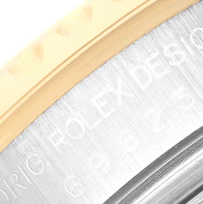 This close-up image shows the engraved side of the case and bezel of a Rolex Yacht-Master 69623 Women
s Steel and Gold (two tone) Grey Dial 69623 Women
s Steel and Gold (two tone) Grey Dial watch.