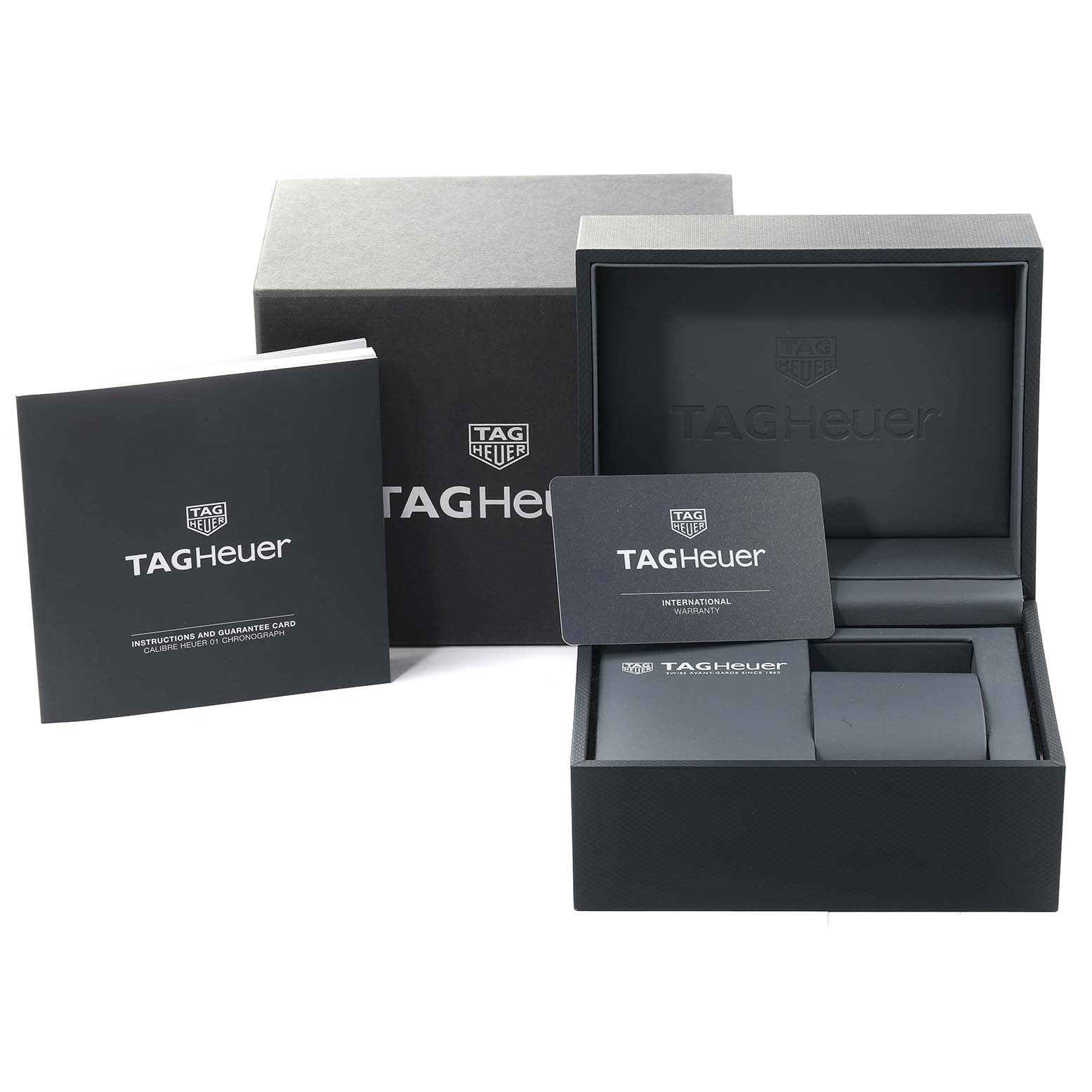 The image shows the box, warranty card, and instruction manual for the Tag Heuer Carrera CAR201W Men's Stainless Steel Black Dial CAR201W Men's Stainless Steel Black Dial model.