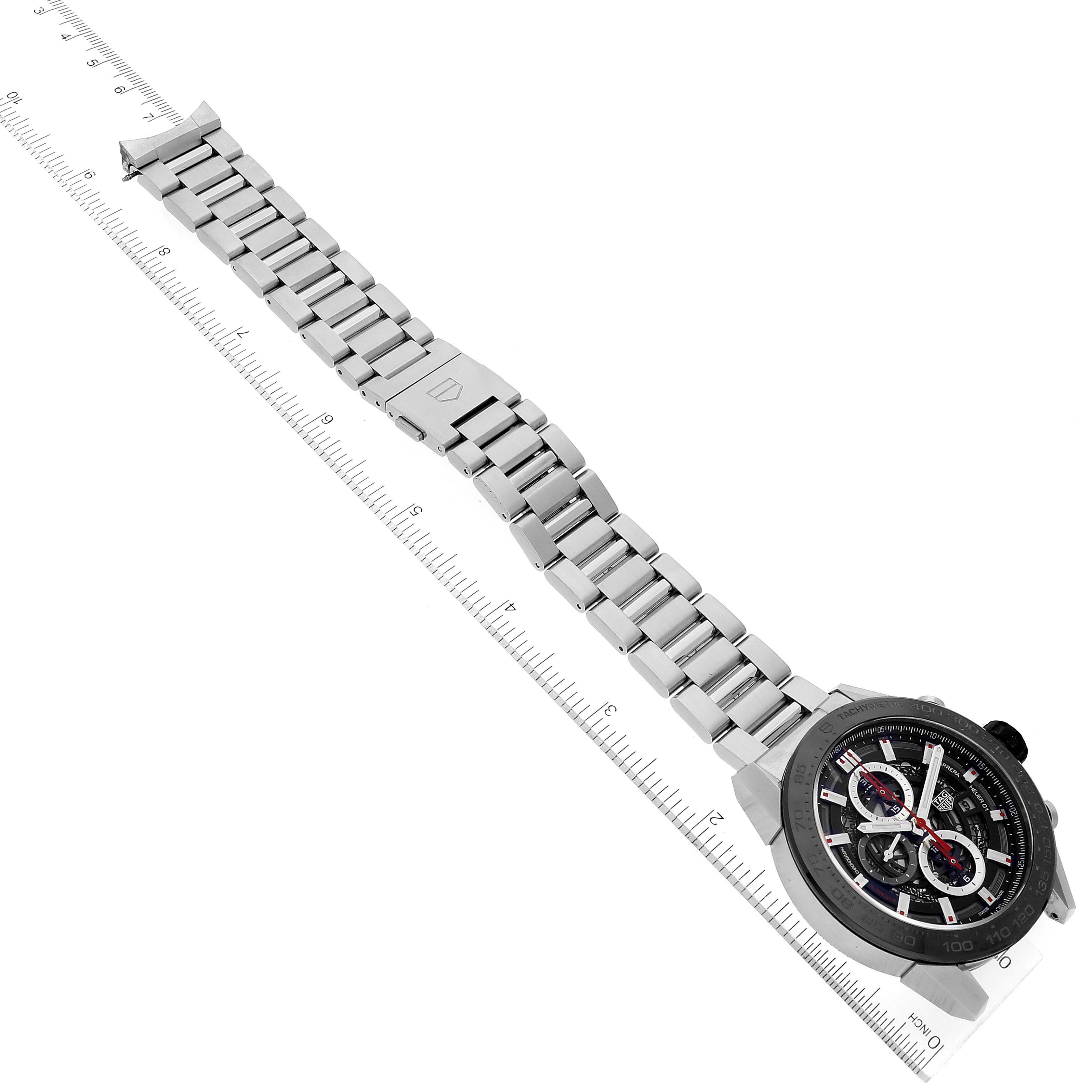The image shows a Tag Heuer Carrera CAR2A1W Men's Stainless Steel Transparent Dial CAR2A1W Men's Stainless Steel Transparent Dial watch laid flat with its full bracelet and clasp, placed next to a measuring scale.