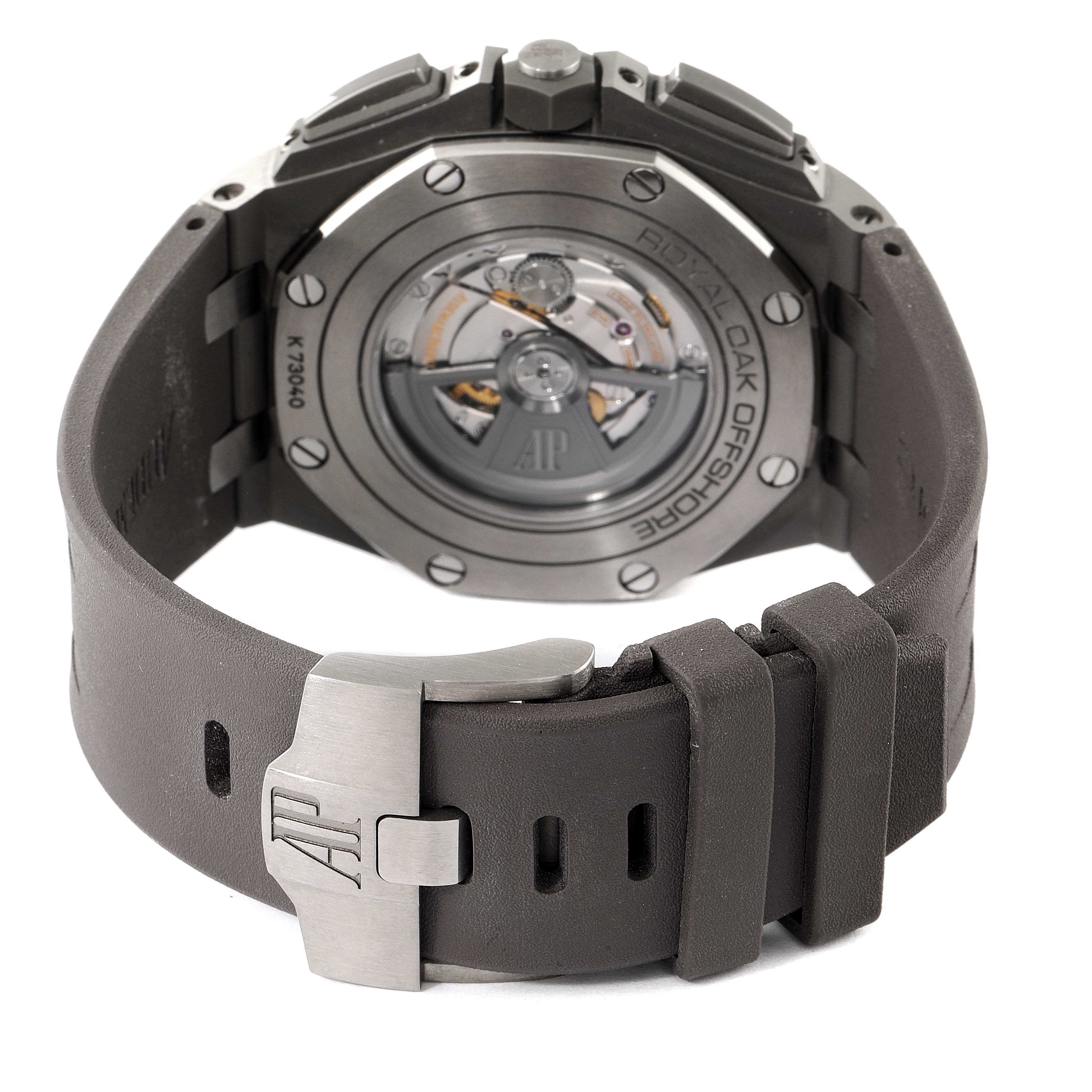 The image shows the back of the Audemars Piguet Royal Oak Offshore 26400IO.OO.A004CA.02 Men's Titanium Grey Dial 26400IO.OO.A004CA.02 Men's Titanium Grey Dial watch, highlighting its movement and buckle.