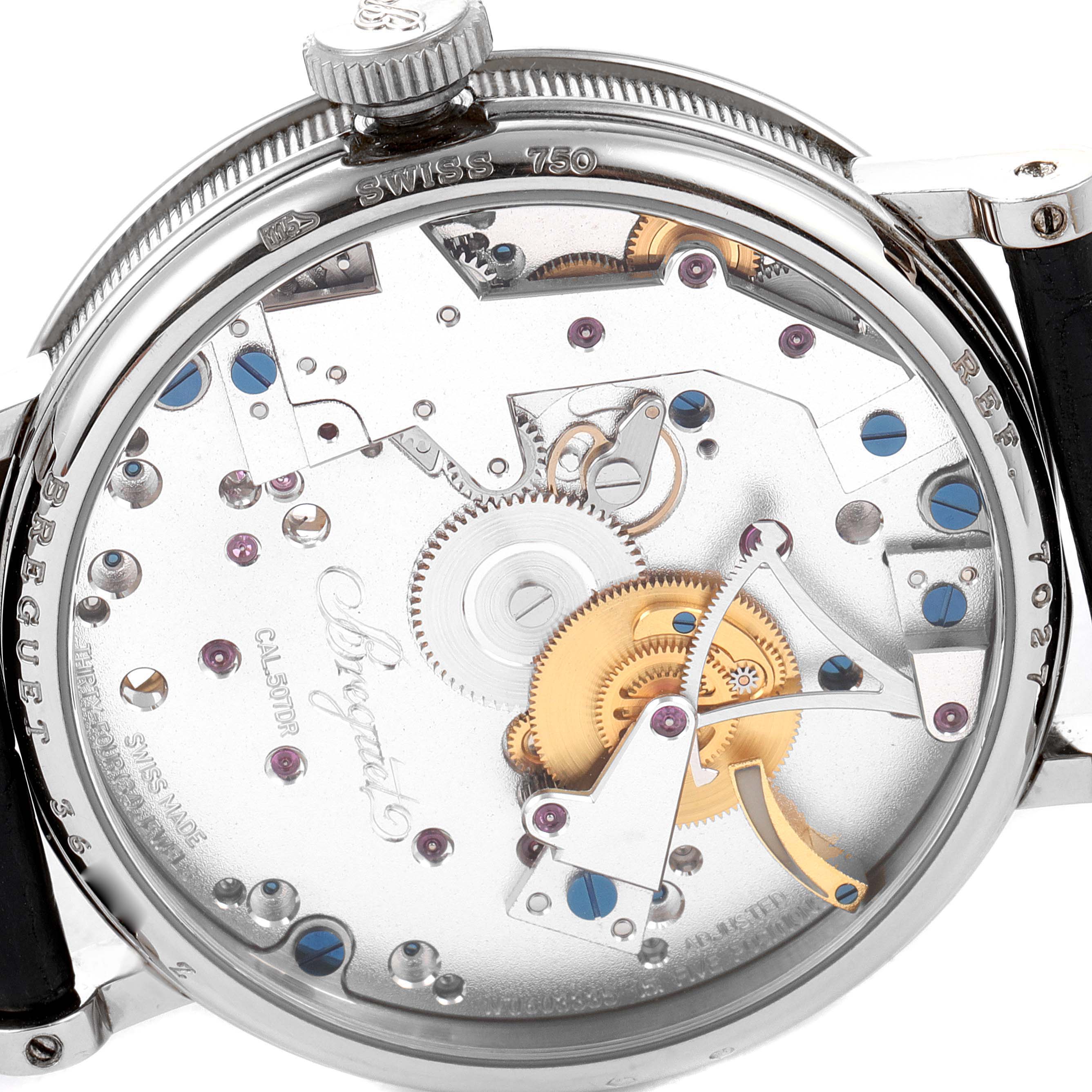 The image shows the backside of a Breguet Tradition 7027BB/11/9V6 Men's White Gold Transparent Dial 7027BB/11/9V6 Men's White Gold Transparent Dial model watch, highlighting its intricate inner mechanisms.