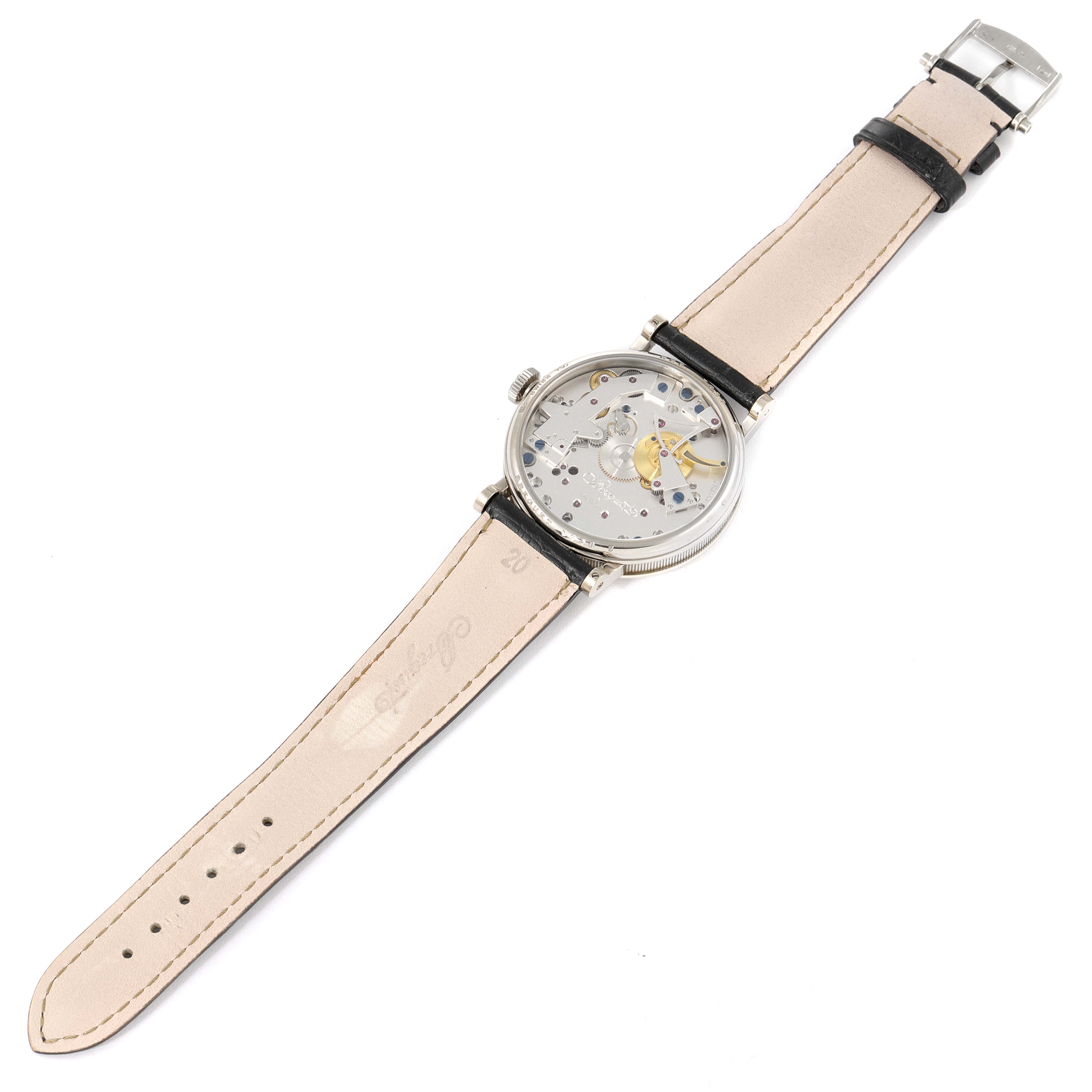 The Breguet Tradition 7027BB/11/9V6 Men's White Gold Transparent Dial 7027BB/11/9V6 Men's White Gold Transparent Dial model watch is shown from a top-down angle, displaying the front face, strap, and buckle.