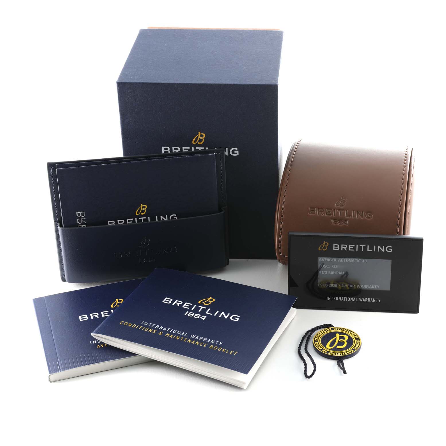 The image shows packaging and accessories for a Breitling Avenger A17318101C1A1 Men's Stainless Steel Blue Dial A17318101C1A1 Men's Stainless Steel Blue Dial watch, including a box, leather case, warranty card, and booklets.