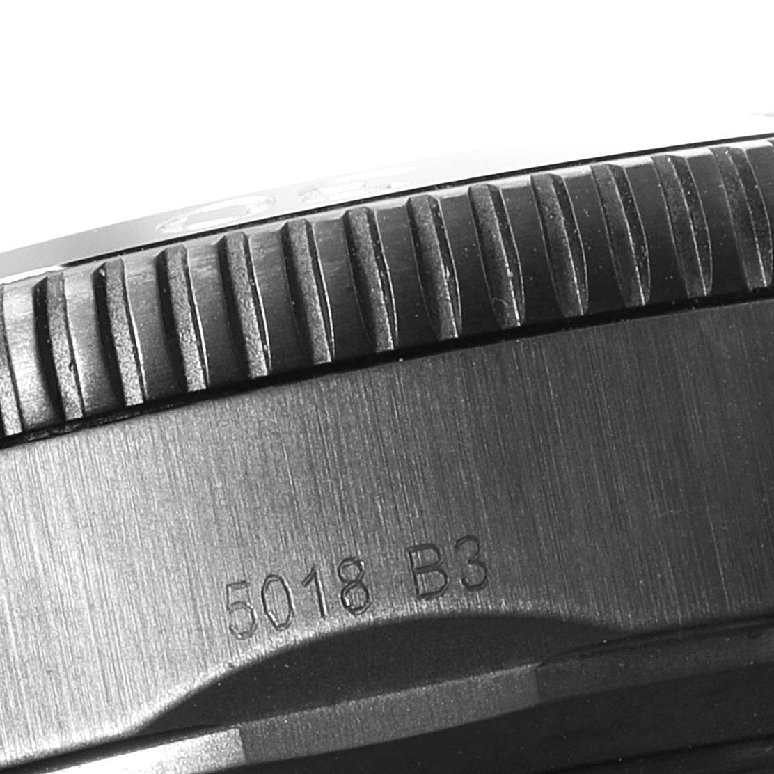 This close-up image shows the side of the bezel and part of the case of a Breitling Superocean M13313 Men's Stainless Steel Blue Dial M13313 Men's Stainless Steel Blue Dial watch, featuring the model number 5018 B3.