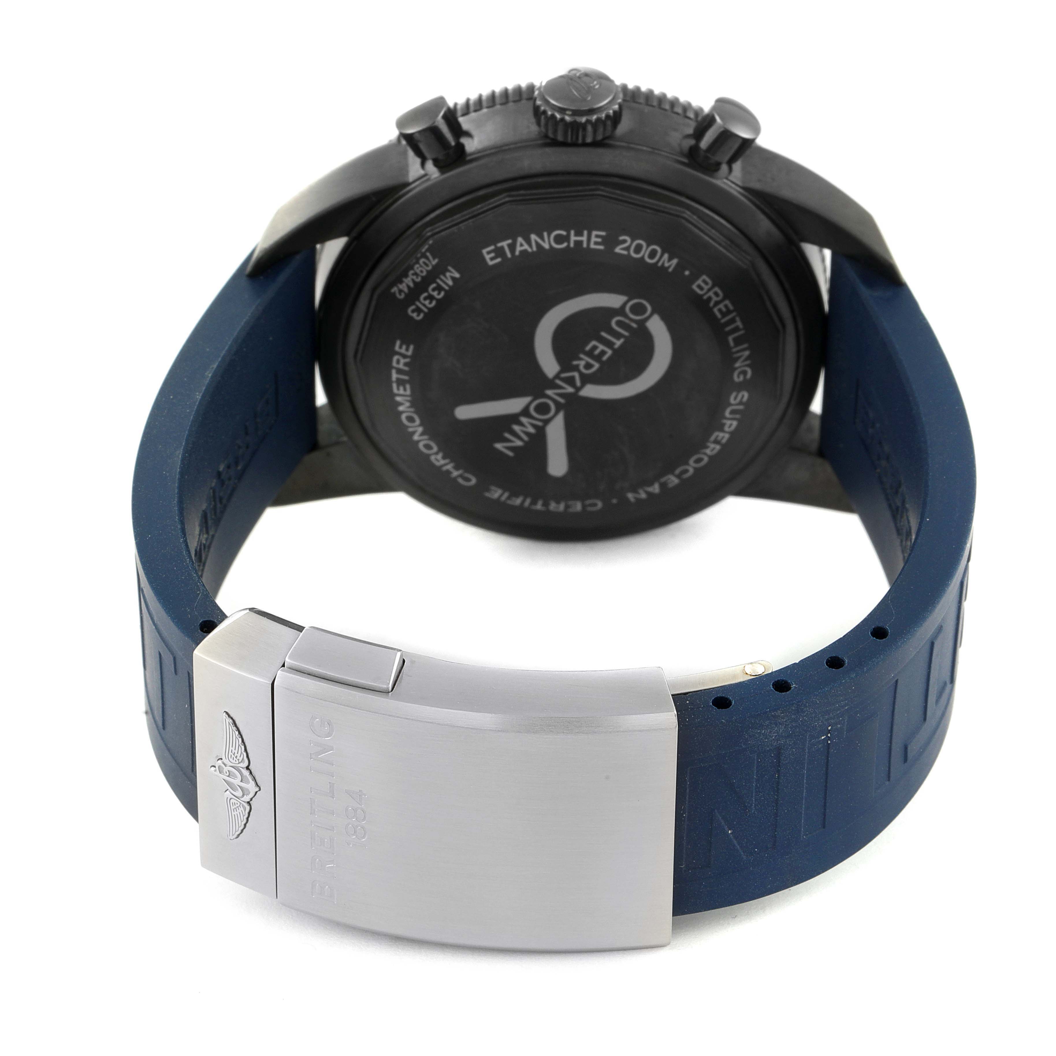 The image shows the back view of a Breitling Superocean M13313 Men's Stainless Steel Blue Dial M13313 Men's Stainless Steel Blue Dial watch, focusing on the casing, crown, and blue strap with the clasp.