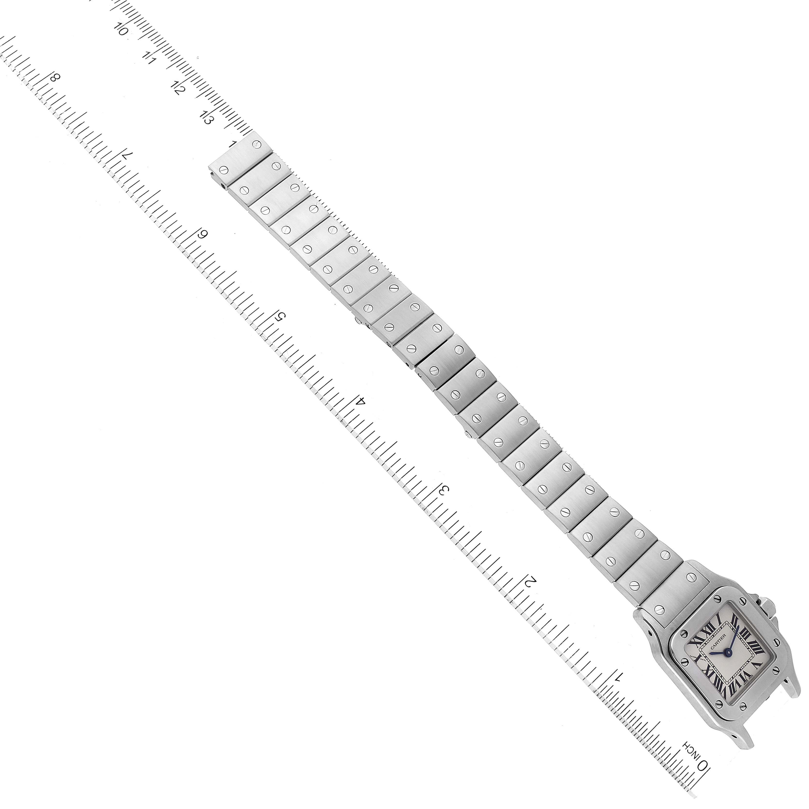 The Santos model by Cartier watch is displayed flat with its full strap extended next to a measuring ruler.