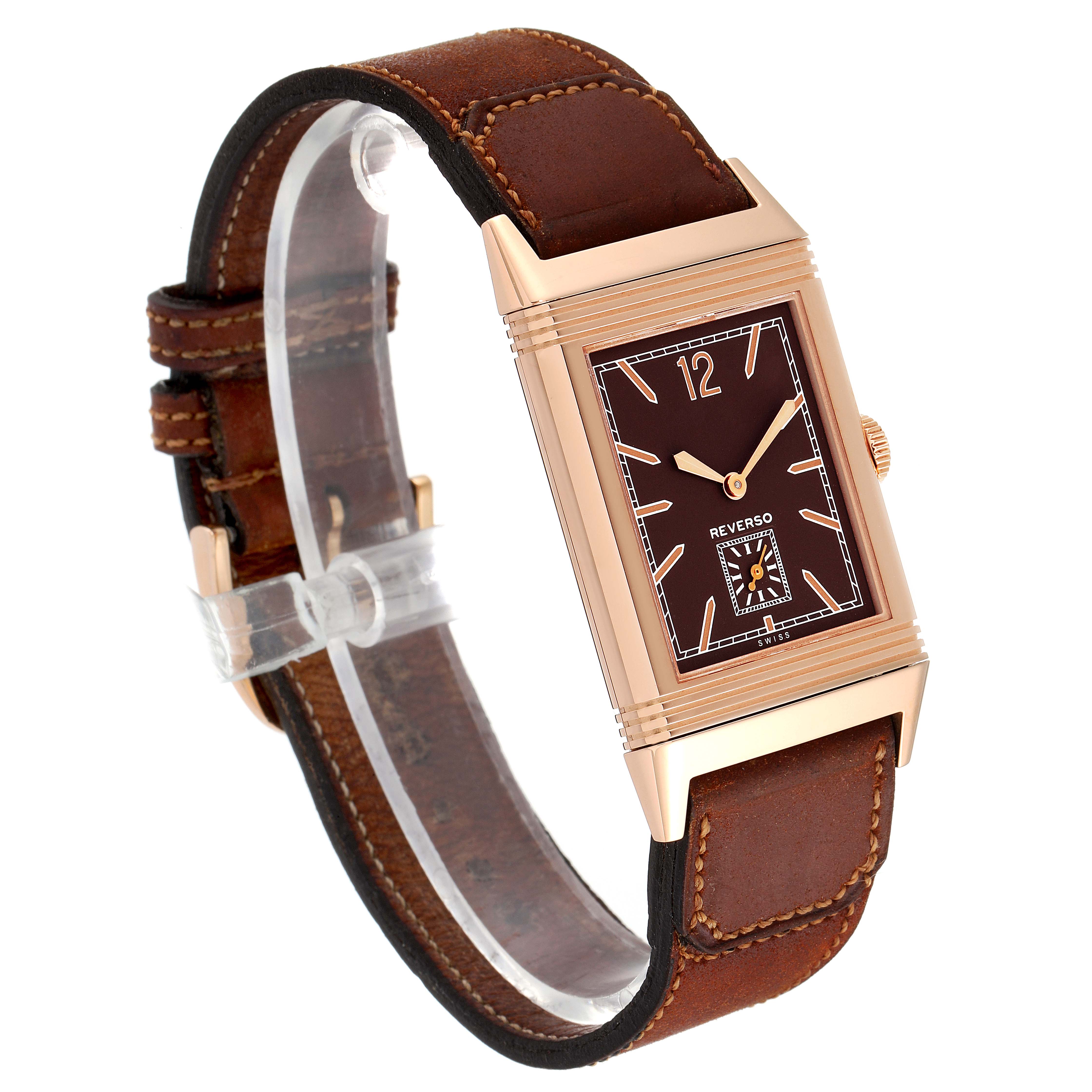 The Jaeger-LeCoultre Reverso watch is shown at a slight angle, highlighting the face, case, crown, and leather strap.