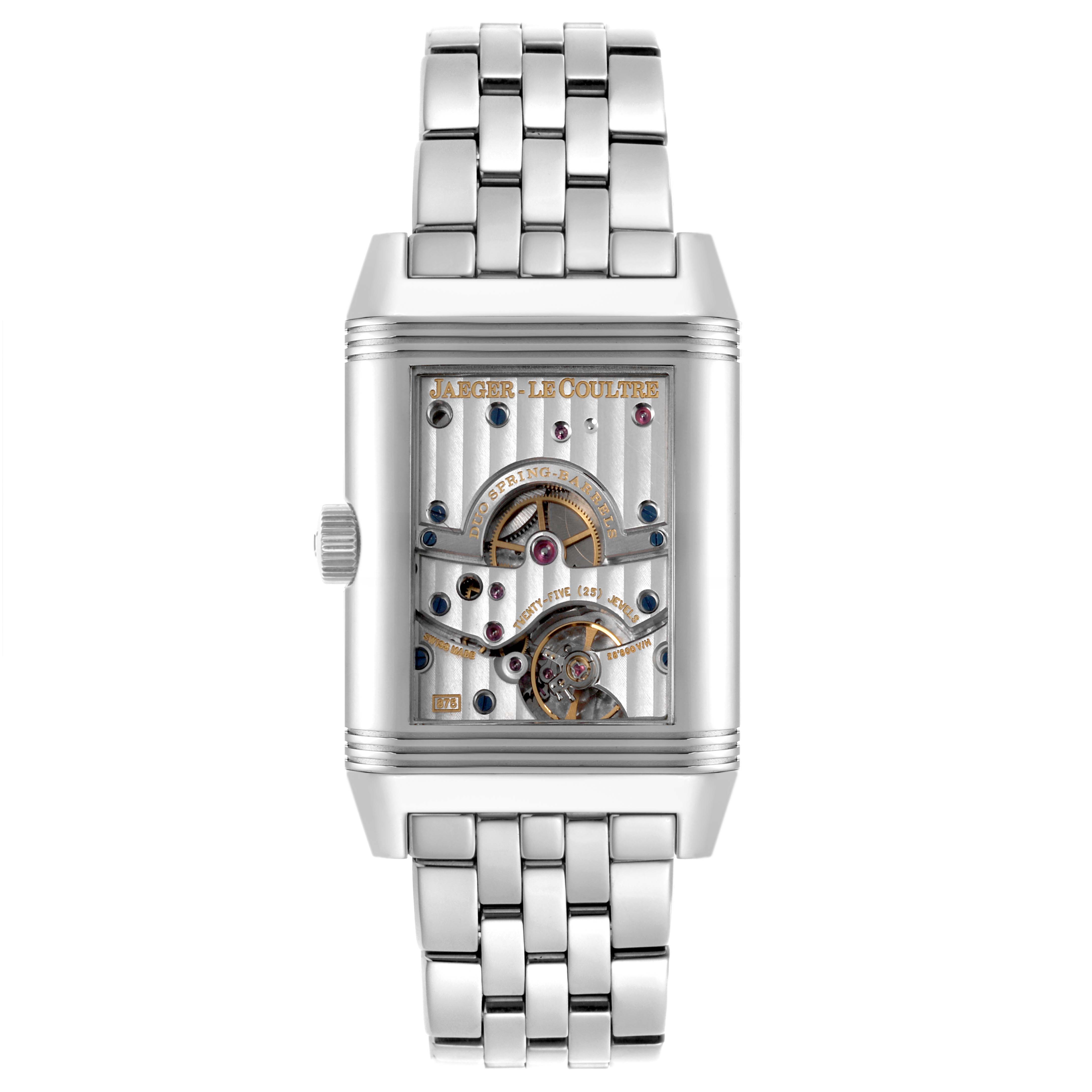 The Jaeger-LeCoultre Reverso watch is shown from a front angle, displaying its mechanical movement and bracelet.