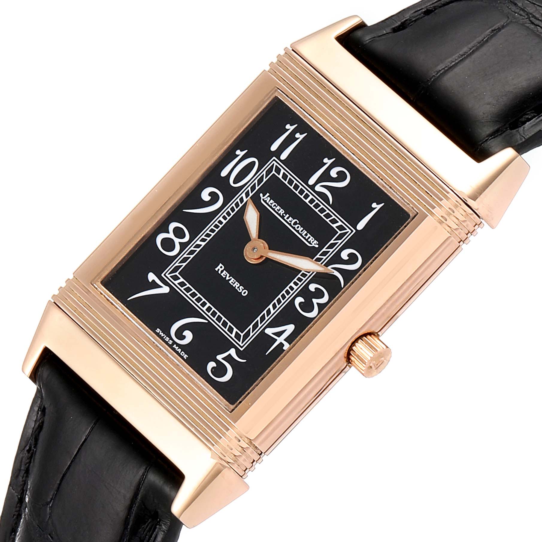 The image shows a top view of a Jaeger-LeCoultre Reverso watch, highlighting its rectangular face, gold casing, and black leather strap.