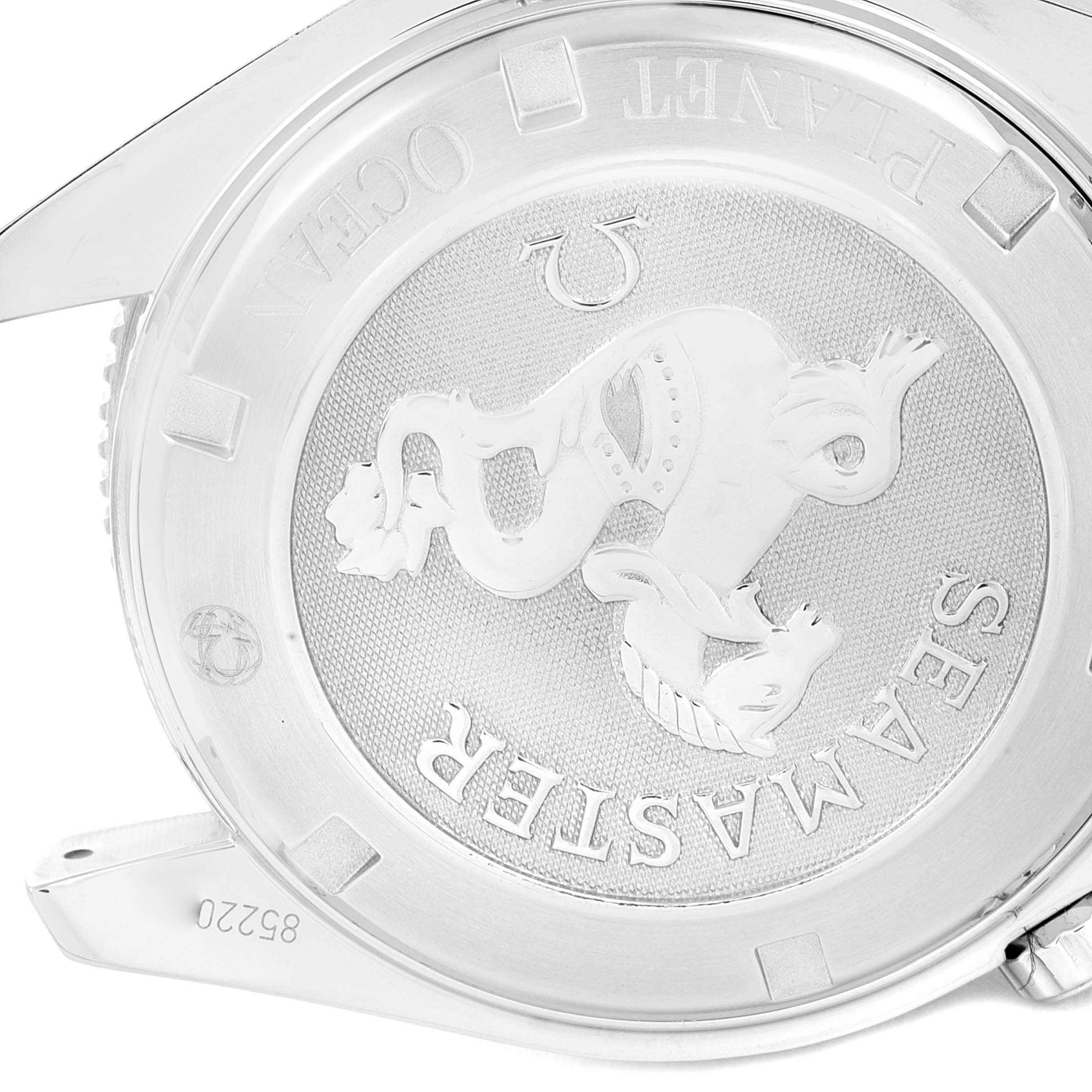 The image shows the case back of an Omega Seamaster Planet Ocean watch, featuring the logo and engraving details.