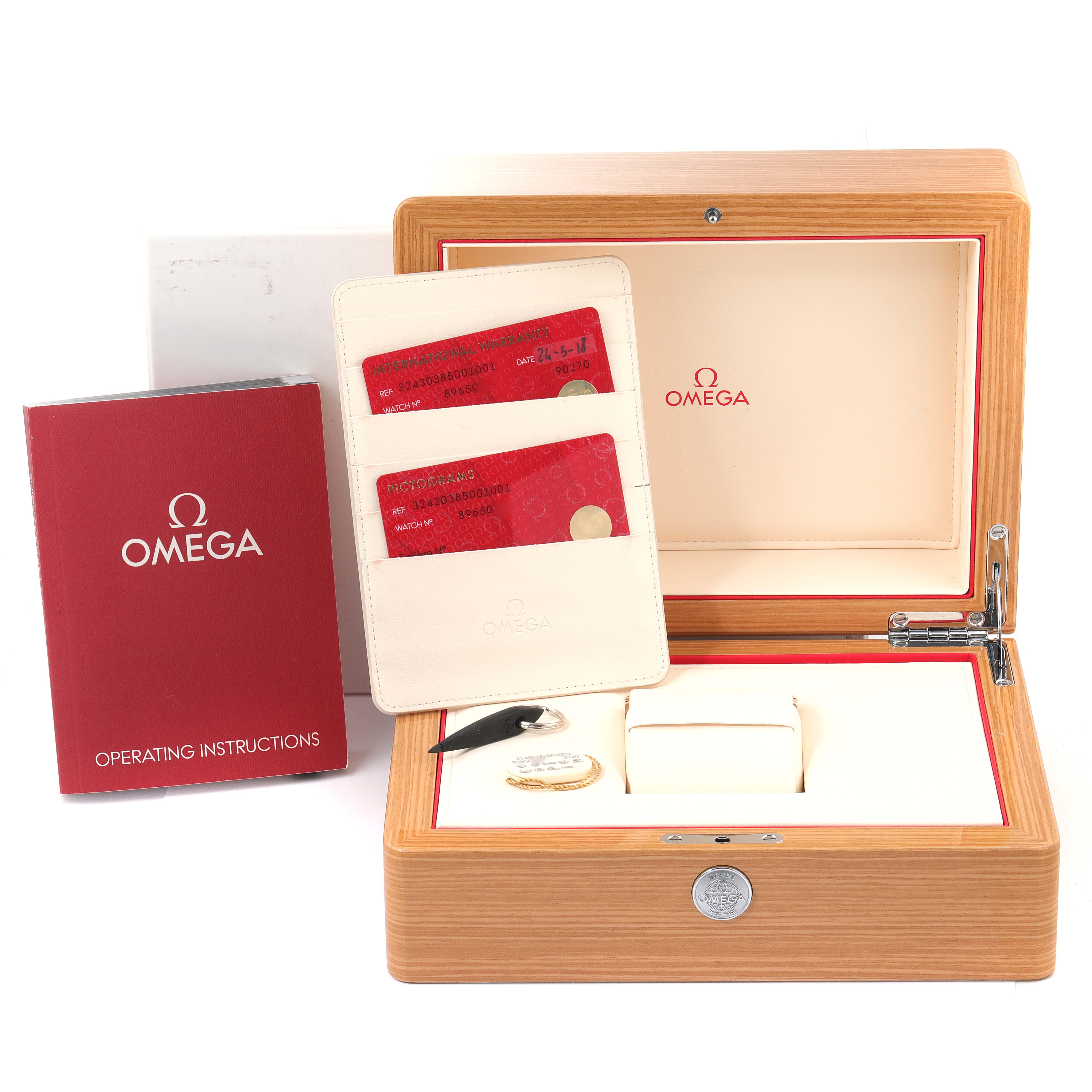 The image shows an Omega Speedmaster 324.30.38.50.01.001 Men
s Stainless Steel Black Dial 324.30.38.50.01.001 Men
s Stainless Steel Black Dial watch box, warranty cards, and operating instructions from the front angle.