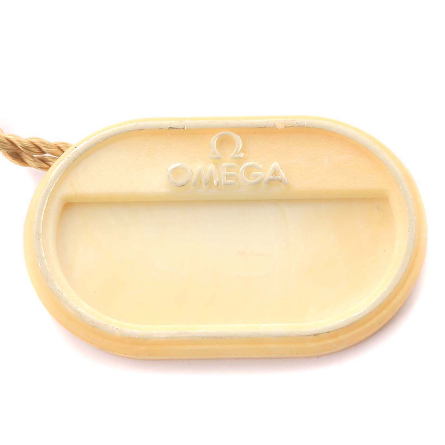 The image shows a top view of an Omega Speedmaster 3222.80.00 Men
s Stainless Steel Blue Dial 3222.80.00 Men
s Stainless Steel Blue Dial accessory tag, featuring the Omega logo.