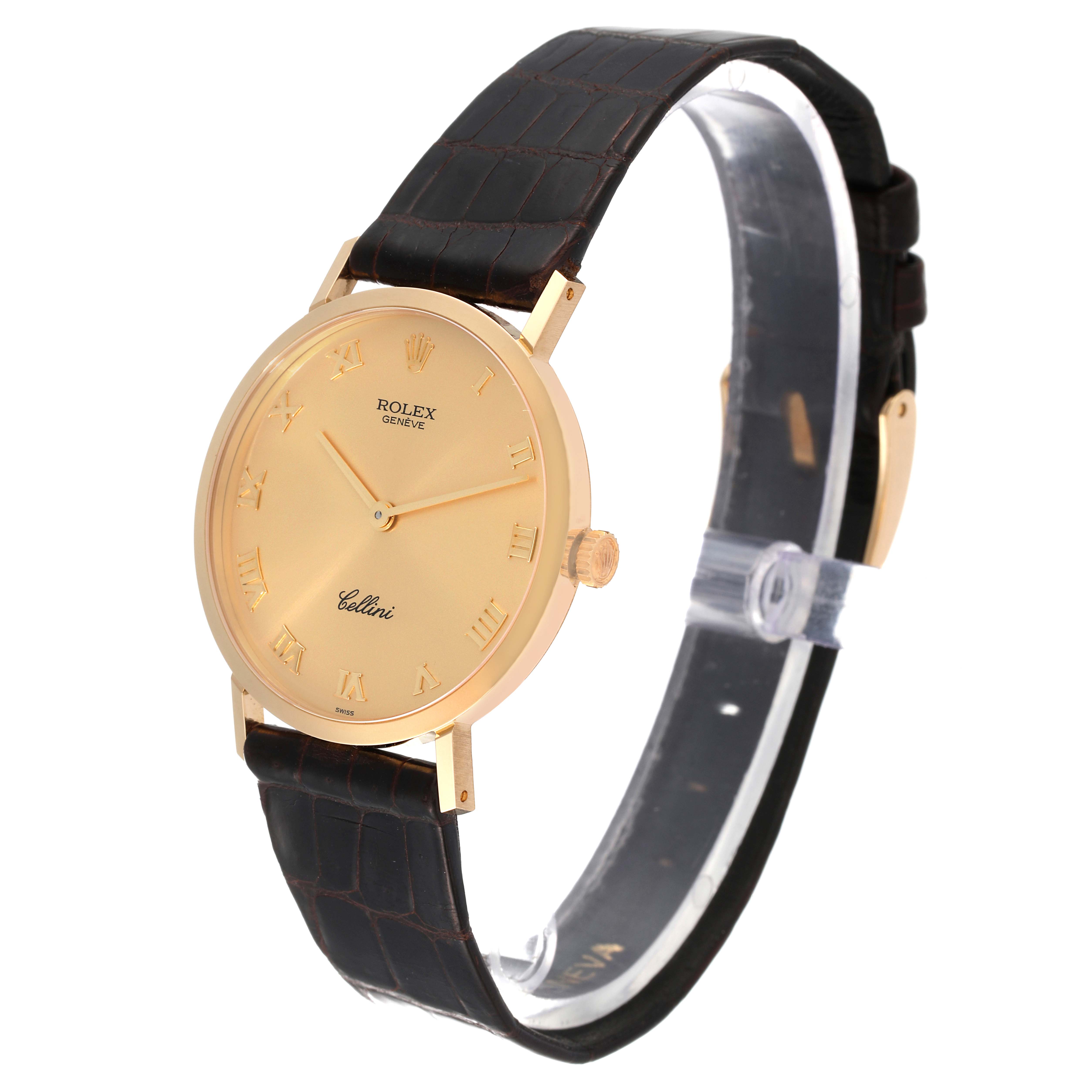 This Rolex Cellini 4112 Men
s Yellow Gold Champagne Dial 4112 Men
s Yellow Gold Champagne Dial watch is shown from an angle displaying the full face, gold casing, black leather strap, and side crown.