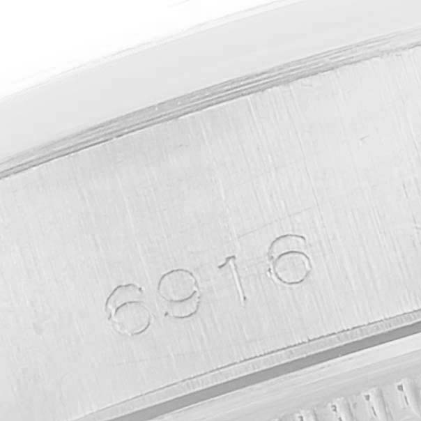 This image shows a close-up view of the case with the reference number "6916" of a Rolex Date 6916 Women's Stainless Steel Blue Dial 6916 Women's Stainless Steel Blue Dial model watch.