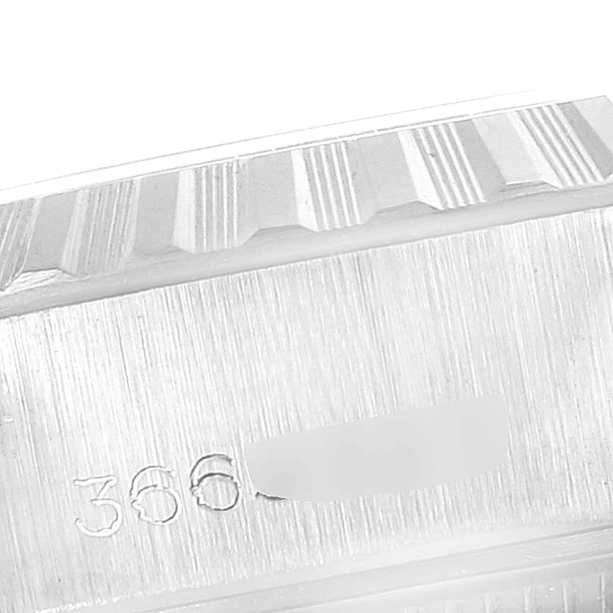 The image shows a close-up of the serial number and fluted bezel of a Rolex Date 6924 Women's Stainless Steel Silver Dial 6924 Women's Stainless Steel Silver Dial watch.
