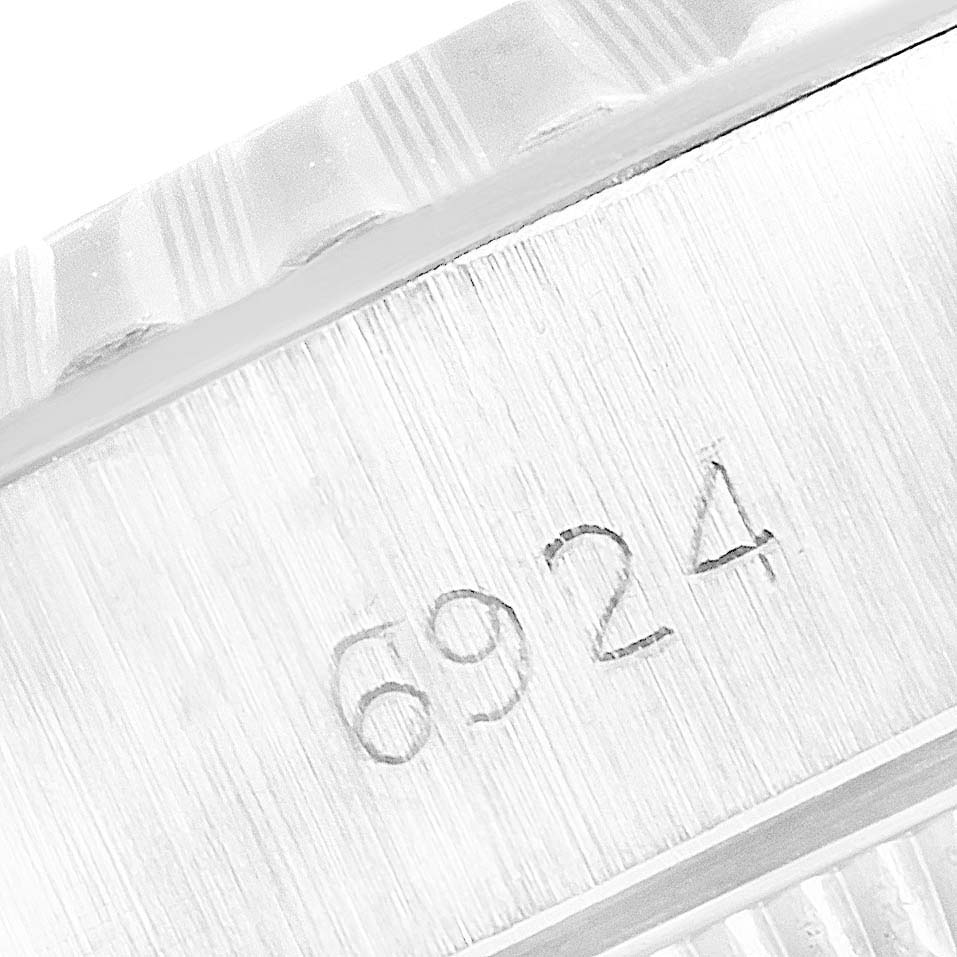 This close-up image shows the fluted bezel and case engraving of the Rolex Date 6924 Women's Stainless Steel Silver Dial 6924 Women's Stainless Steel Silver Dial model with serial number 6924.