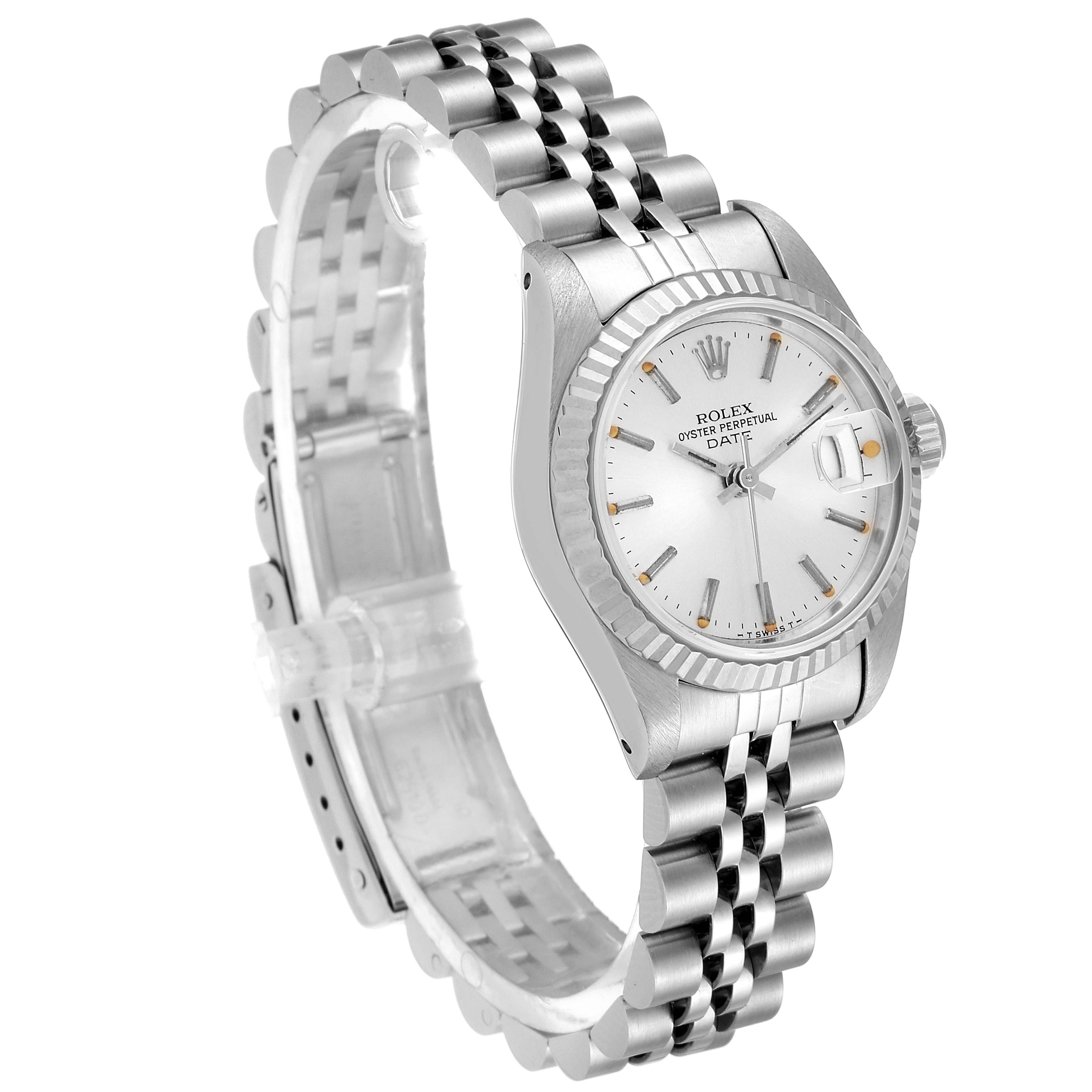 The image shows a Rolex Date 69174 Women's Stainless Steel Silver Dial 69174 Women's Stainless Steel Silver Dial model watch from an angled perspective highlighting the face, fluted bezel, and jubilee bracelet.
