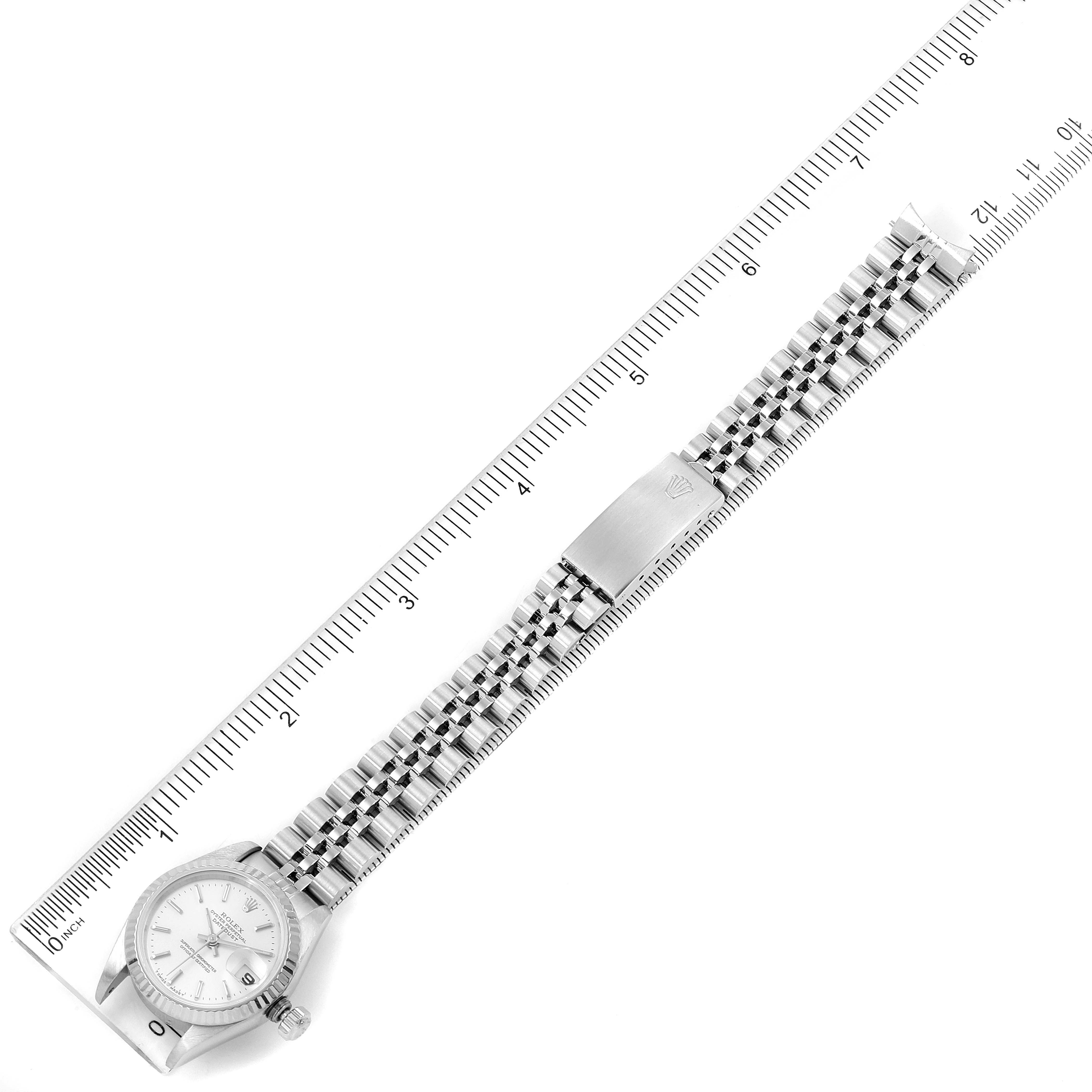 The image shows a Rolex Datejust 69174 Women
s Stainless Steel Silver Dial 69174 Women
s Stainless Steel Silver Dial watch, displayed flat with the face, bracelet, and clasp visible, aligned with a ruler.