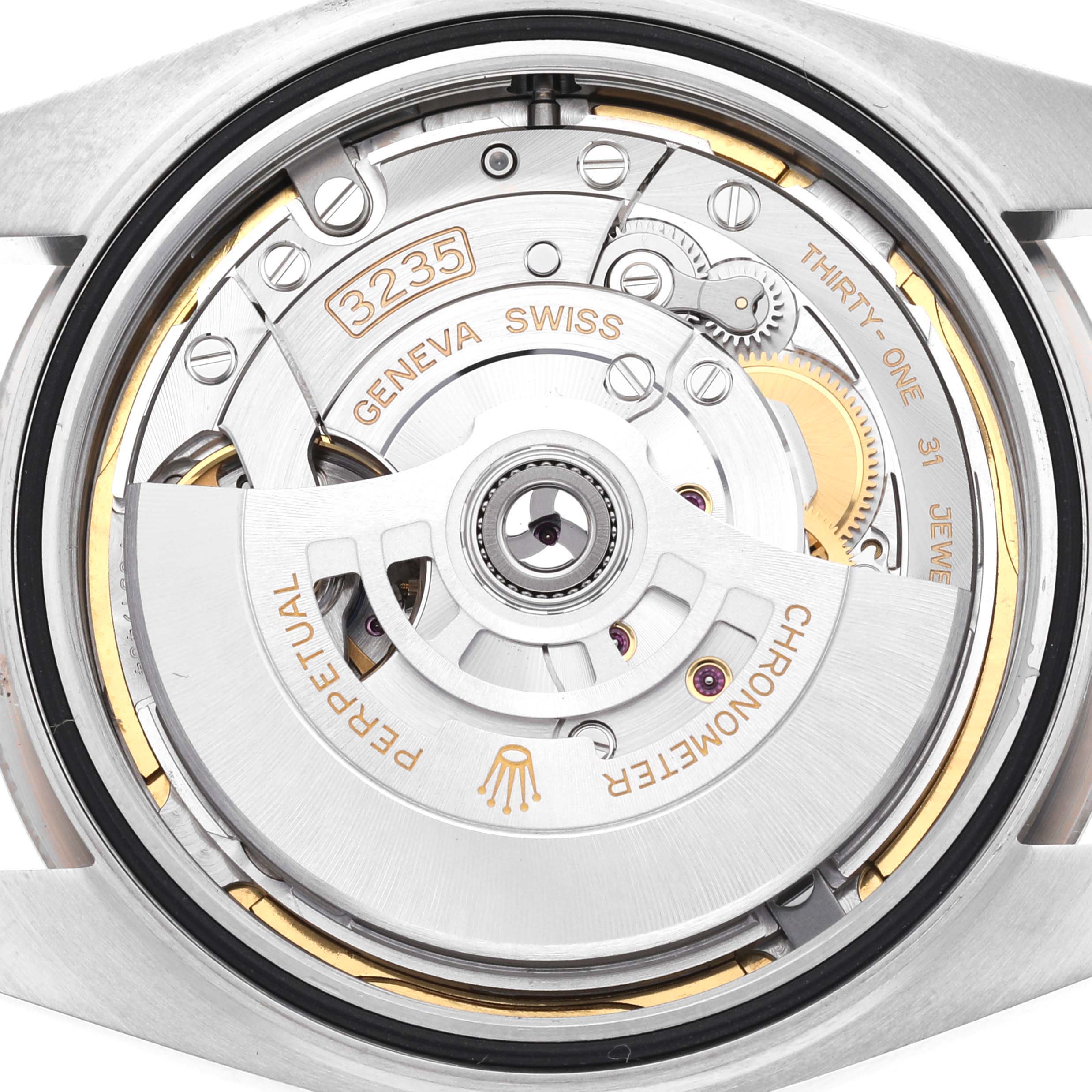 This image shows the inner mechanism of a Rolex Datejust 41 126334 Men
s Stainless Steel Green Dial 126334 Men
s Stainless Steel Green Dial watch from a back angle, highlighting its intricate components and inscriptions.