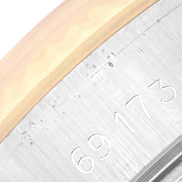 The image shows a close-up of the serial number engraving on a Rolex Datejust 69173 Women's Steel and Gold (two tone) Champagne Dial 69173 Women's Steel and Gold (two tone) Champagne Dial model watch case.