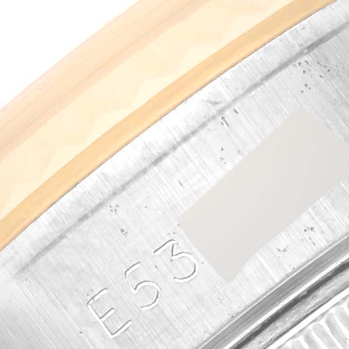 The image shows a close-up of the side of a Rolex Datejust 69173 Women's Steel and Gold (two tone) Champagne Dial 69173 Women's Steel and Gold (two tone) Champagne Dial watch, focusing on the brushed metal part with engraving.