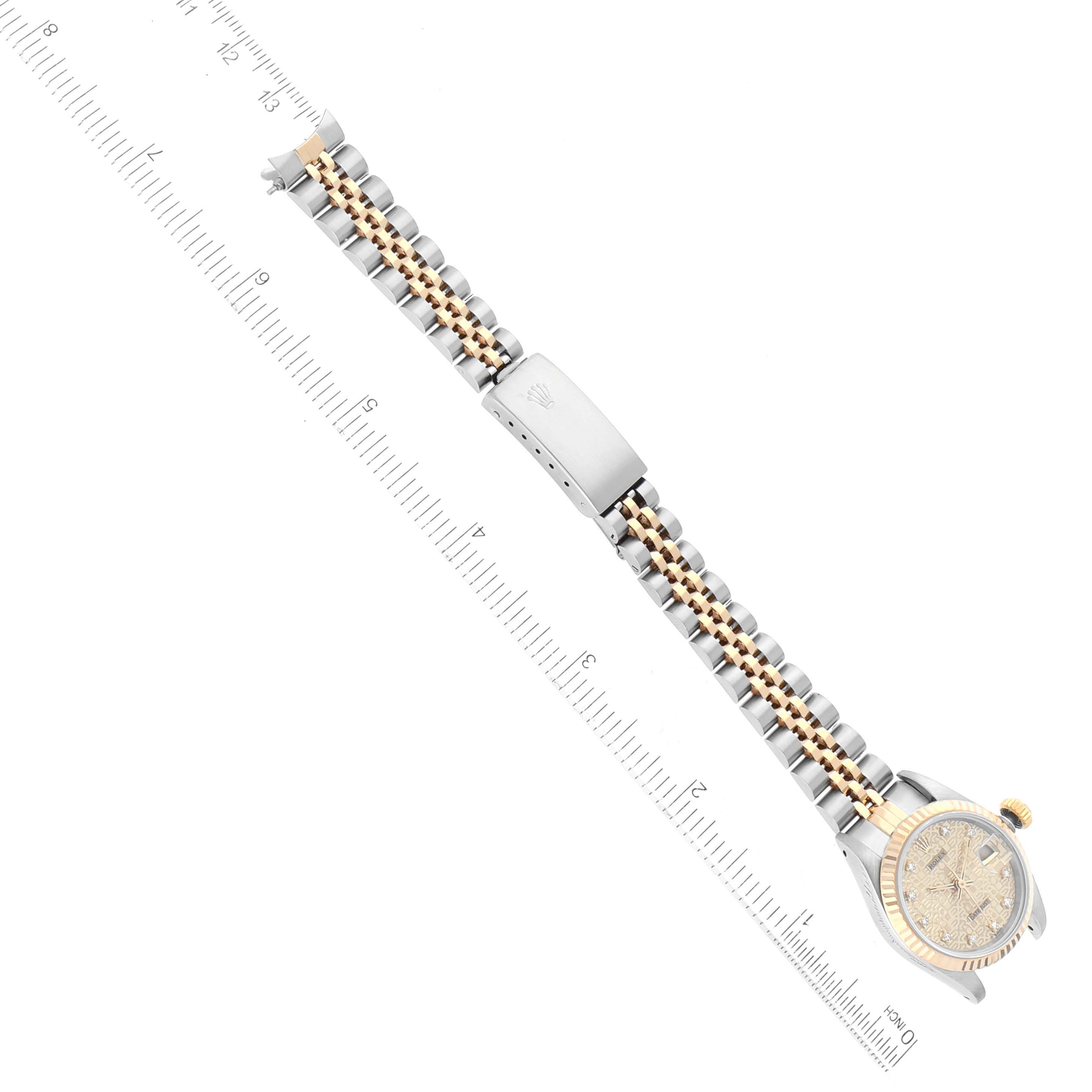 This image shows a top-down view of the Rolex Datejust 69173 Women's Steel and Gold (two tone) Champagne Dial 69173 Women's Steel and Gold (two tone) Champagne Dial watch, focusing on the dial, bracelet, and clasp alongside a ruler for scale.