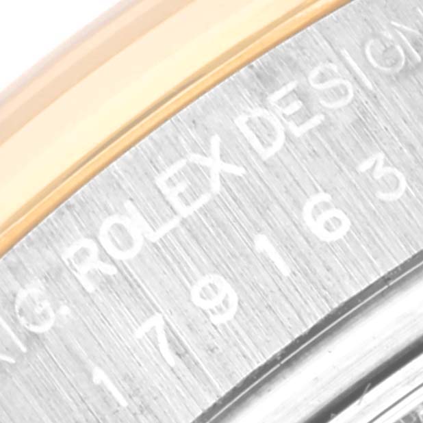 This close-up shows the engraved side of the Rolex Datejust 179163 Women's Steel and Gold (two tone) Blue Dial 179163 Women's Steel and Gold (two tone) Blue Dial model case, displaying the model and brand name.