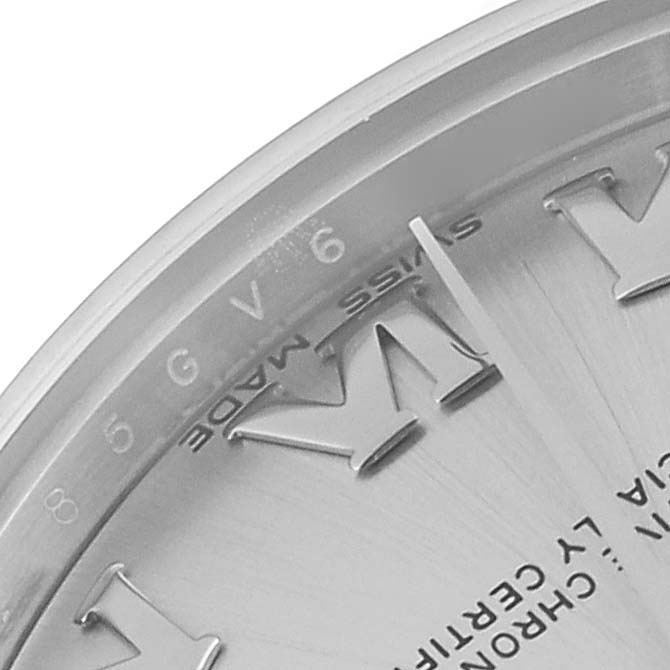 The image shows a close-up of the dial and bezel of a mid-size Rolex watch, focusing on the "VI" numeral and "Swiss Made" text.