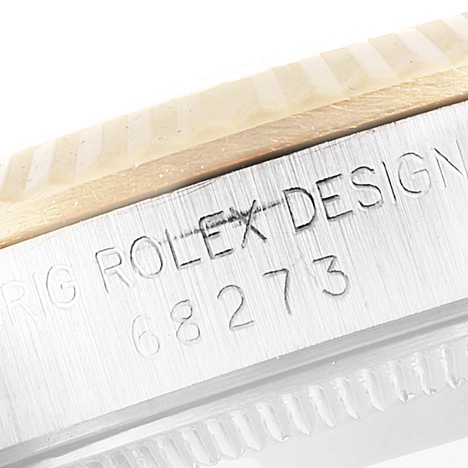 The image shows a close-up of the Rolex Mid-Size 68273 Women
s Steel and Gold (two tone) White Dial 68273 Women
s Steel and Gold (two tone) White Dial watch case edge, focusing on the model number 68273 engraving.