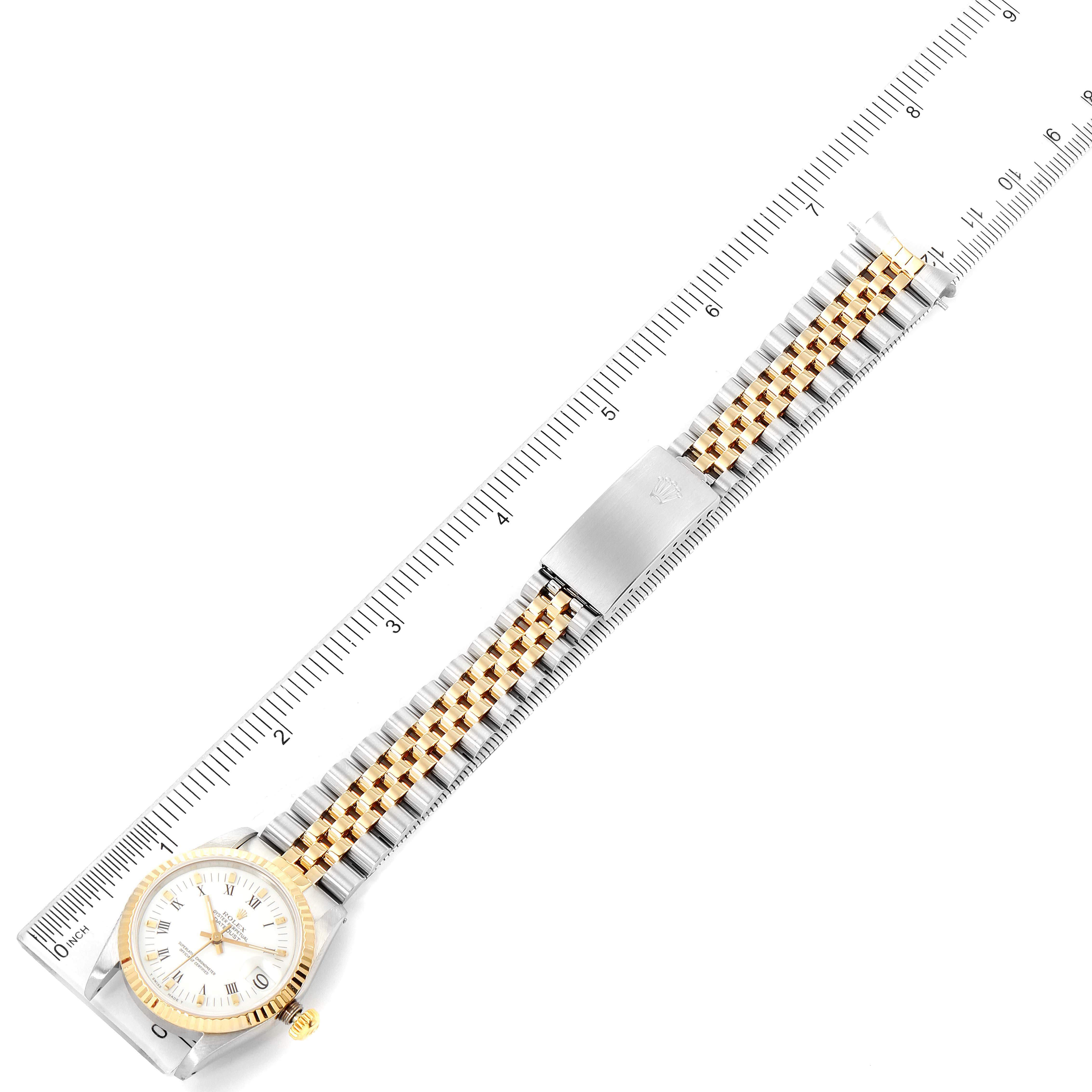 The watch is a Mid-Size Rolex model shown from above, displaying the full bracelet, clasp, and face alongside a measurement scale.
