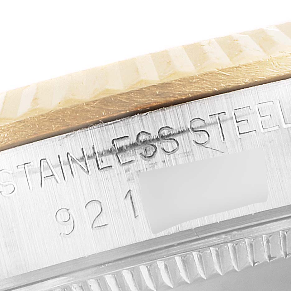 This image displays a close-up of the side engraving and bezel of a Rolex Mid-Size 68273 Women
s Steel and Gold (two tone) White Dial 68273 Women
s Steel and Gold (two tone) White Dial watch.