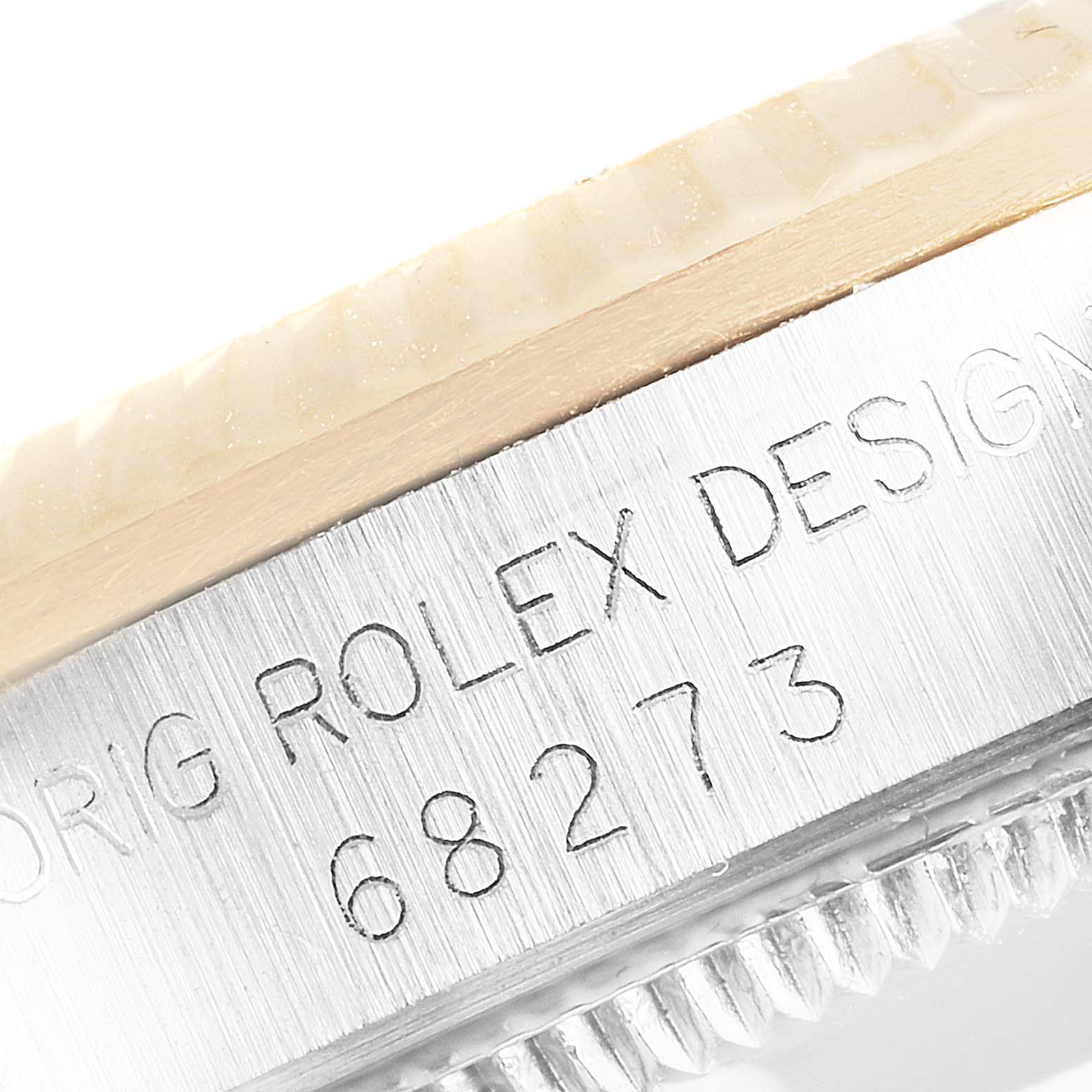 This close-up image shows the model number and inscription on the side of the bezel of a Rolex Mid-Size 68273 Women
s Steel and Gold (two tone) Champagne Dial 68273 Women
s Steel and Gold (two tone) Champagne Dial 68273 watch.