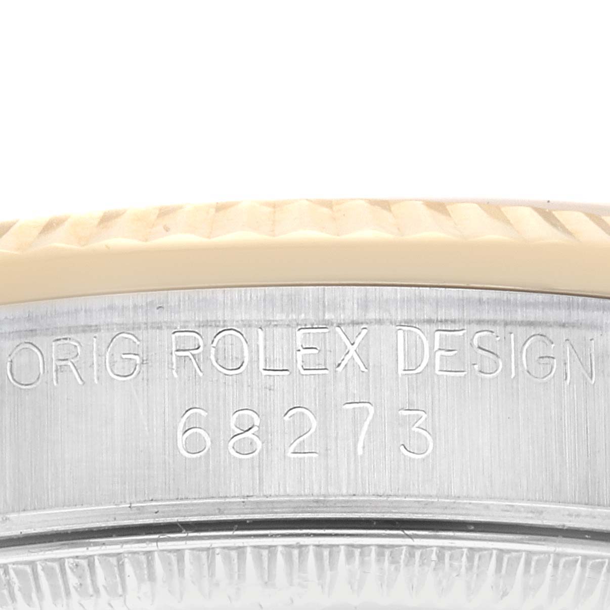 The image shows a close-up of the side of a Rolex Mid-Size 68273 Women's Steel and Gold (two tone) Champagne Dial 68273 Women's Steel and Gold (two tone) Champagne Dial model watch, highlighting its bezel and engraved model number 68273.