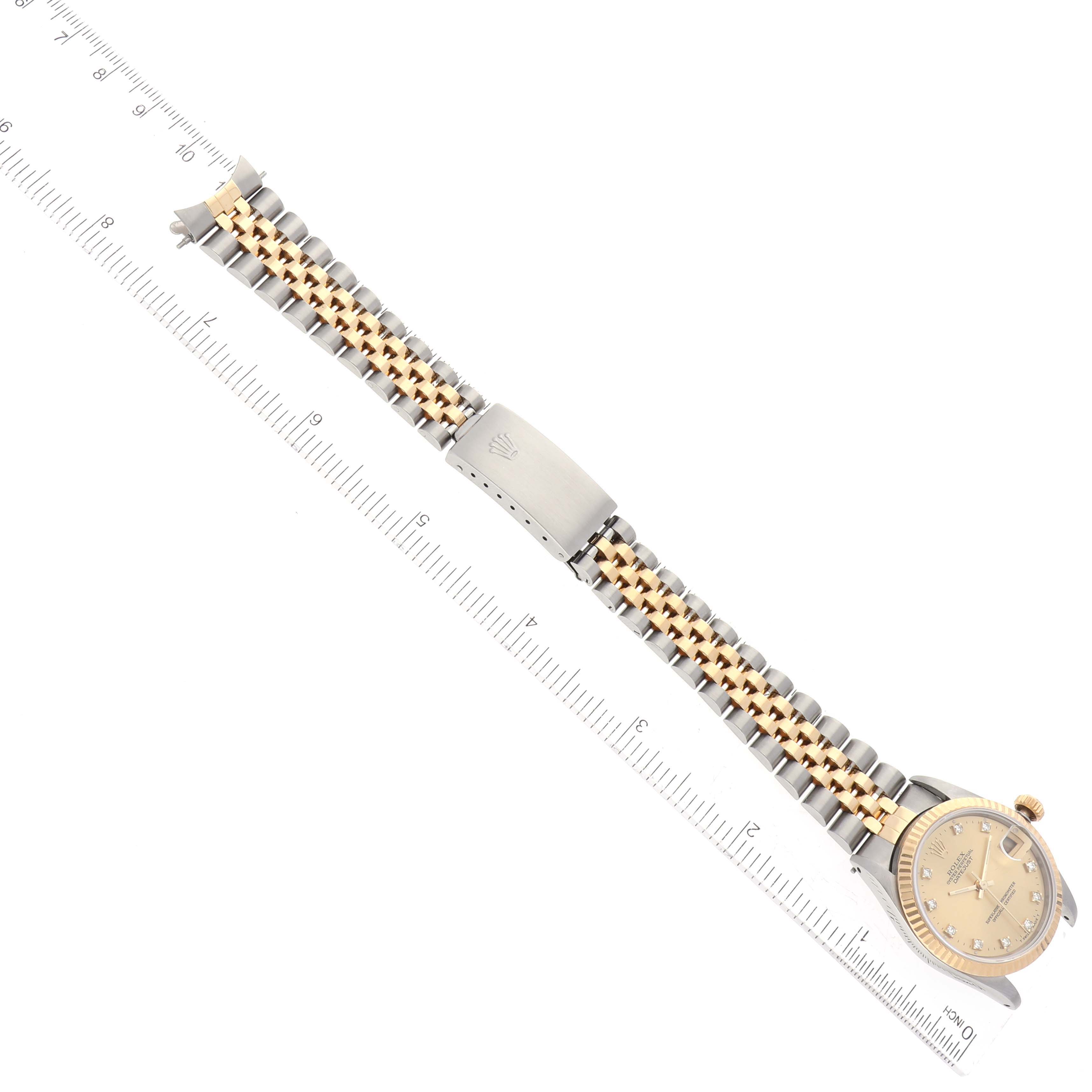 The Rolex Mid-Size 68273 Women's Steel and Gold (two tone) Champagne Dial 68273 Women's Steel and Gold (two tone) Champagne Dial model watch is shown from an overhead angle, displaying the full bracelet, clasp, and watch face.