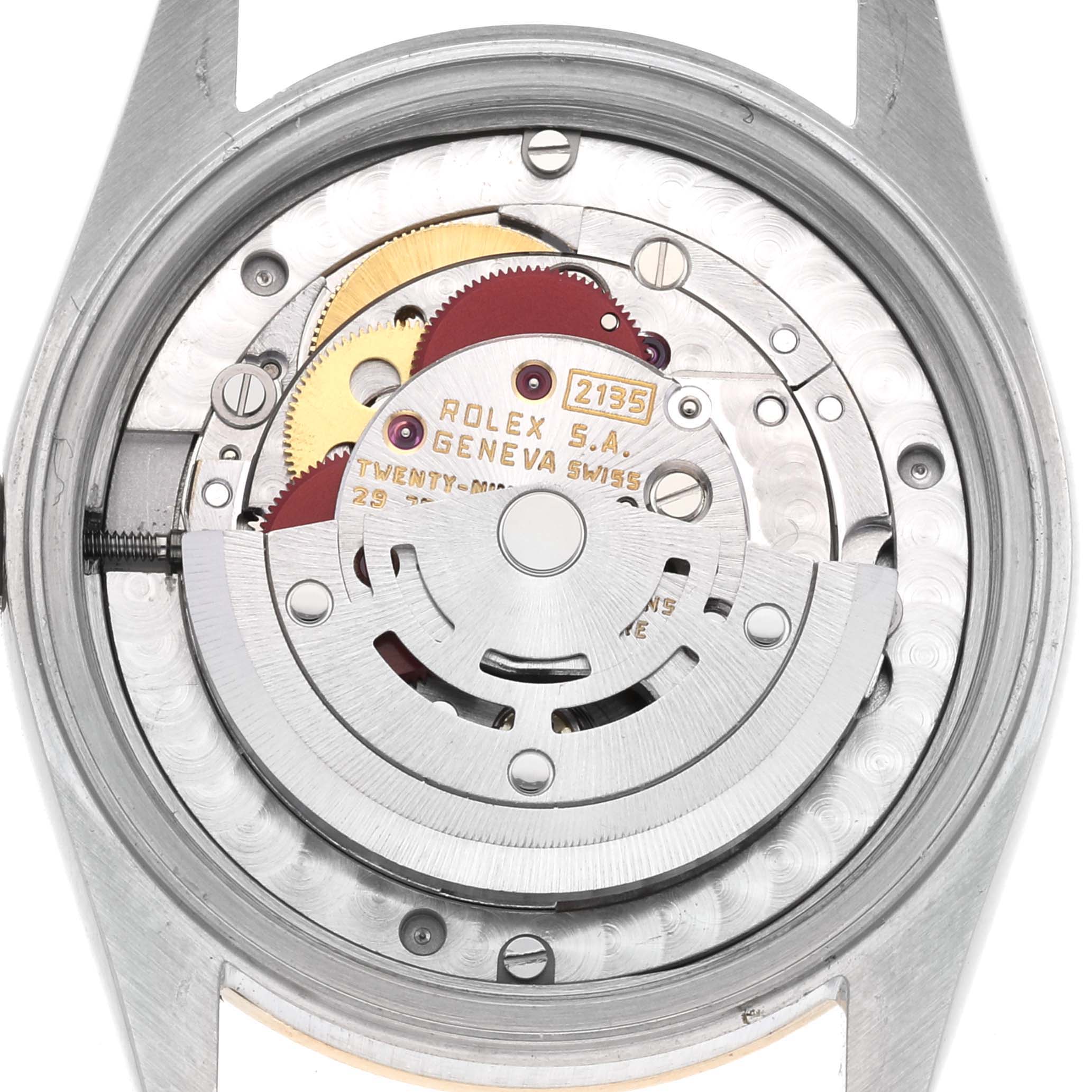 The image shows a close-up of the internal mechanism of the Mid-Size Rolex watch model, highlighting the gears and movement components.