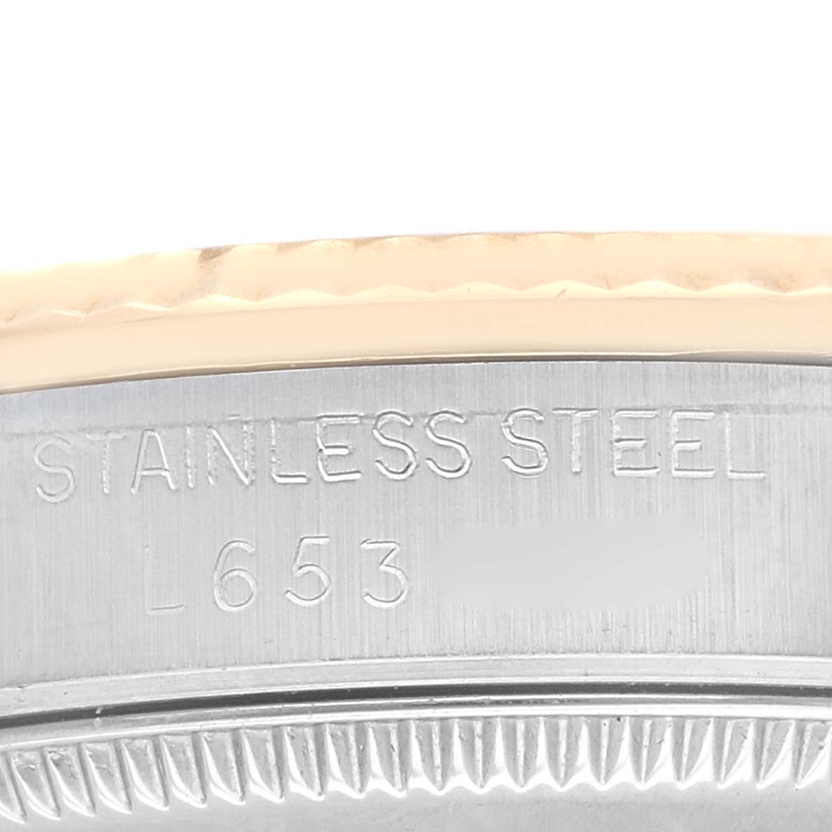 This image shows the case back of a Mid-Size Rolex watch, displaying its "STAINLESS STEEL" marking and model number engraving.