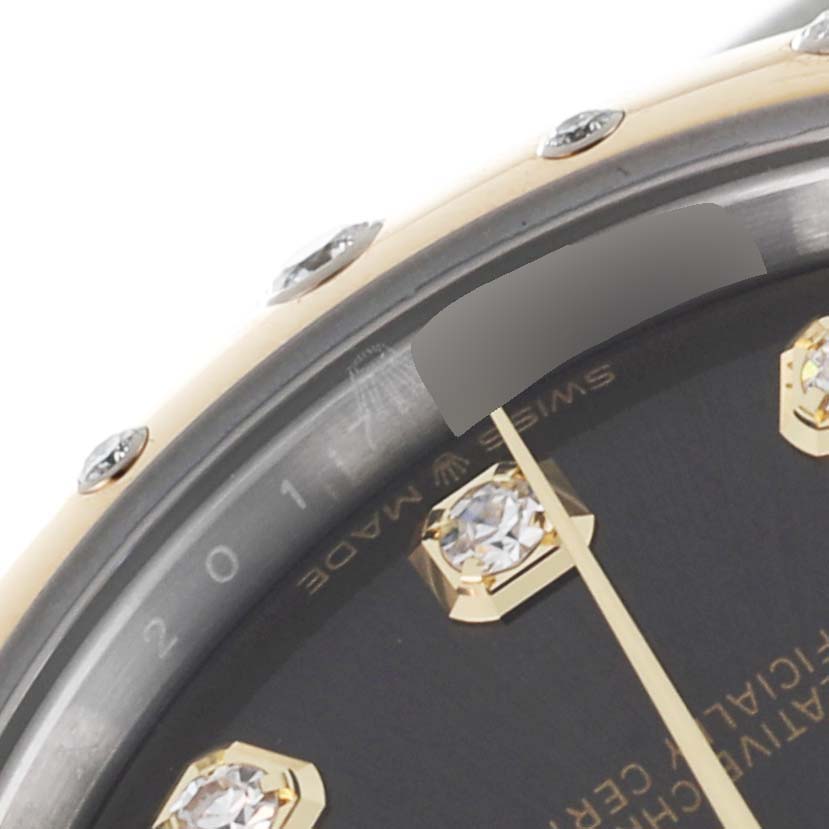 The image shows a close-up angle of the Rolex Mid-Size 278343 Women's Steel and Gold (two tone) Grey Dial 278343 Women's Steel and Gold (two tone) Grey Dial watch dial, bezel, and diamond hour marker.