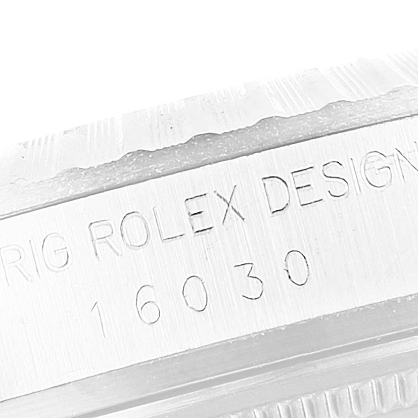 The image shows a close-up of the engraved side of the bezel of the Vintage Collection model by Rolex, displaying the serial number "16030."