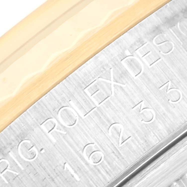 This is a close-up of the casing and bezel of a Rolex Datejust 16233 Men's Steel and Gold (two tone) Grey Dial 16233 Men's Steel and Gold (two tone) Grey Dial watch showing the engraved model number.