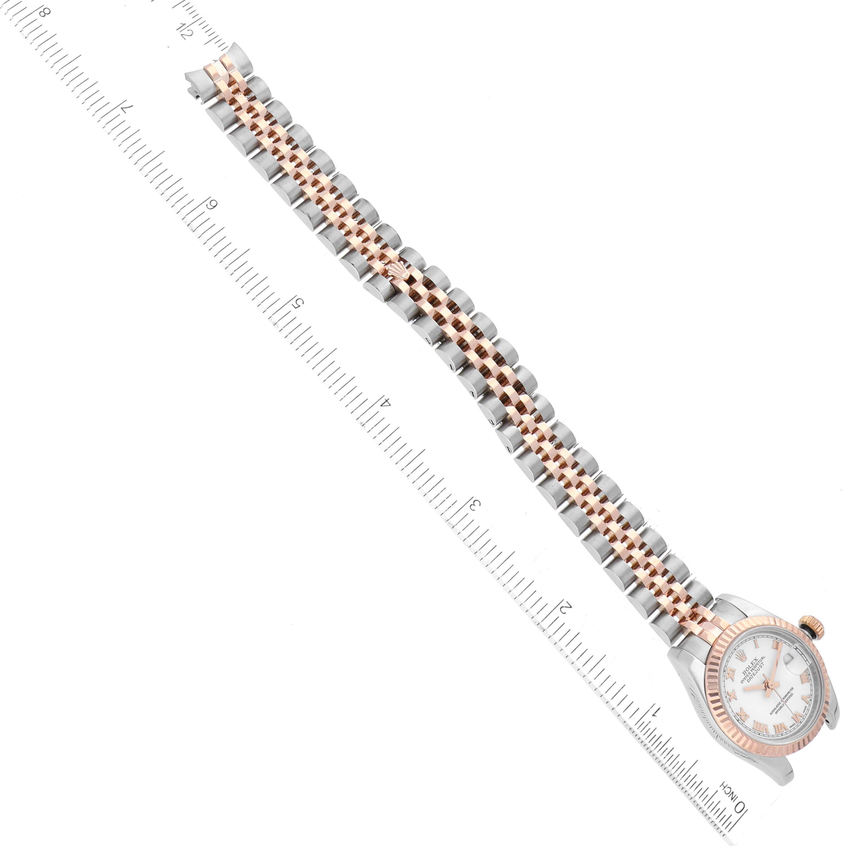 The image shows a Rolex Datejust 179171 Women's Steel and Gold (two tone) White Dial 179171 Women's Steel and Gold (two tone) White Dial watch laid flat, highlighting its bracelet and dial, with a ruler for scale.