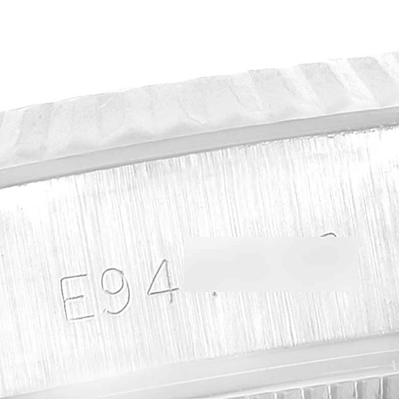 This close-up image shows the serial number engraving on the side of the case of a Rolex Datejust 69174 Women's Stainless Steel Silver Dial 69174 Women's Stainless Steel Silver Dial watch.