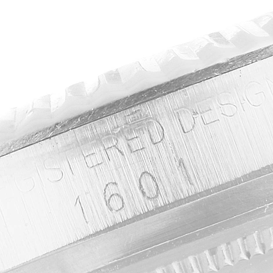 This close-up image of the Rolex Vintage Collection 1601 Men's Stainless Steel Silver Dial 1601 Men's Stainless Steel Silver Dial watch shows the engraved model number on the side of the case.