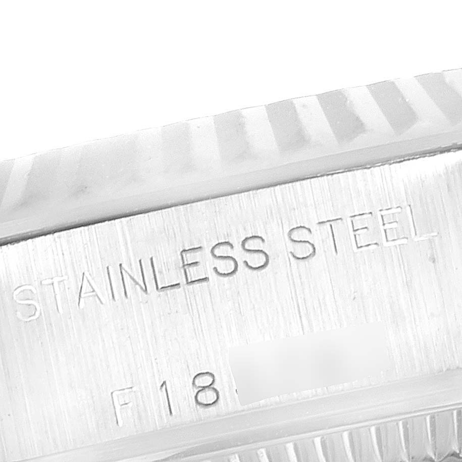 This image shows a close-up of the stainless steel casing and fluted bezel of the Rolex Datejust 79174 Women's Stainless Steel Pink Dial 79174 Women's Stainless Steel Pink Dial watch.