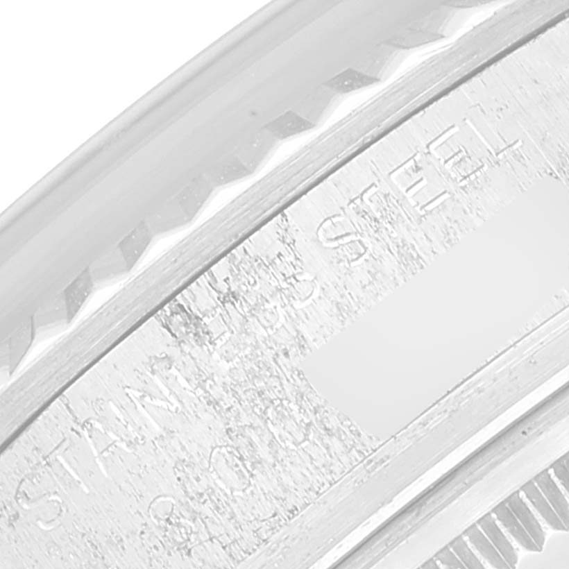 This is a close-up of the side of a Vintage Collection Rolex watch, showing detailed engravings on the stainless steel case.