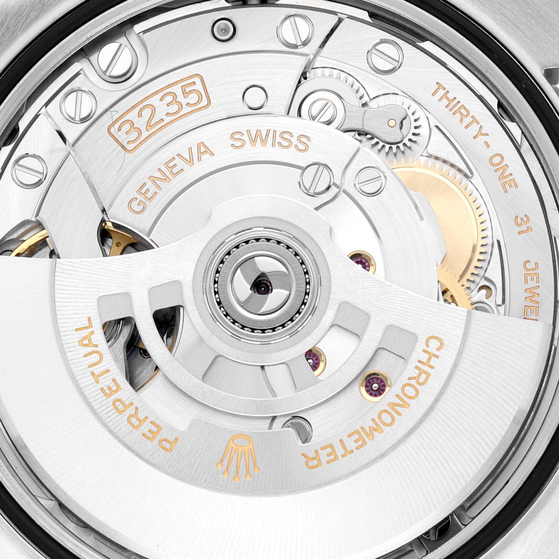 The image shows the movement of the Rolex Datejust 126234 Men's Stainless Steel Grey Dial 126234 Men's Stainless Steel Grey Dial watch, viewed from the back, displaying intricate gears and inscriptions.