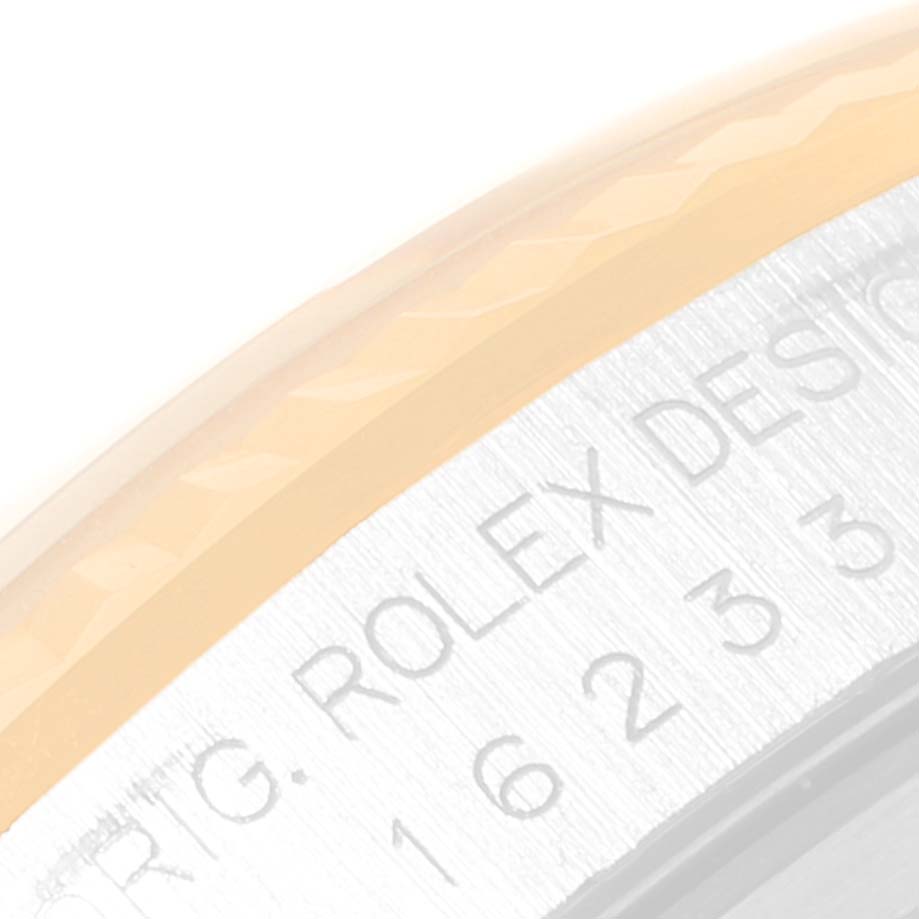 This close-up image of the Rolex Datejust 16233 Men's Steel and Gold (two tone) Black Dial 16233 Men's Steel and Gold (two tone) Black Dial watch shows the engraved bezel area with the model number.