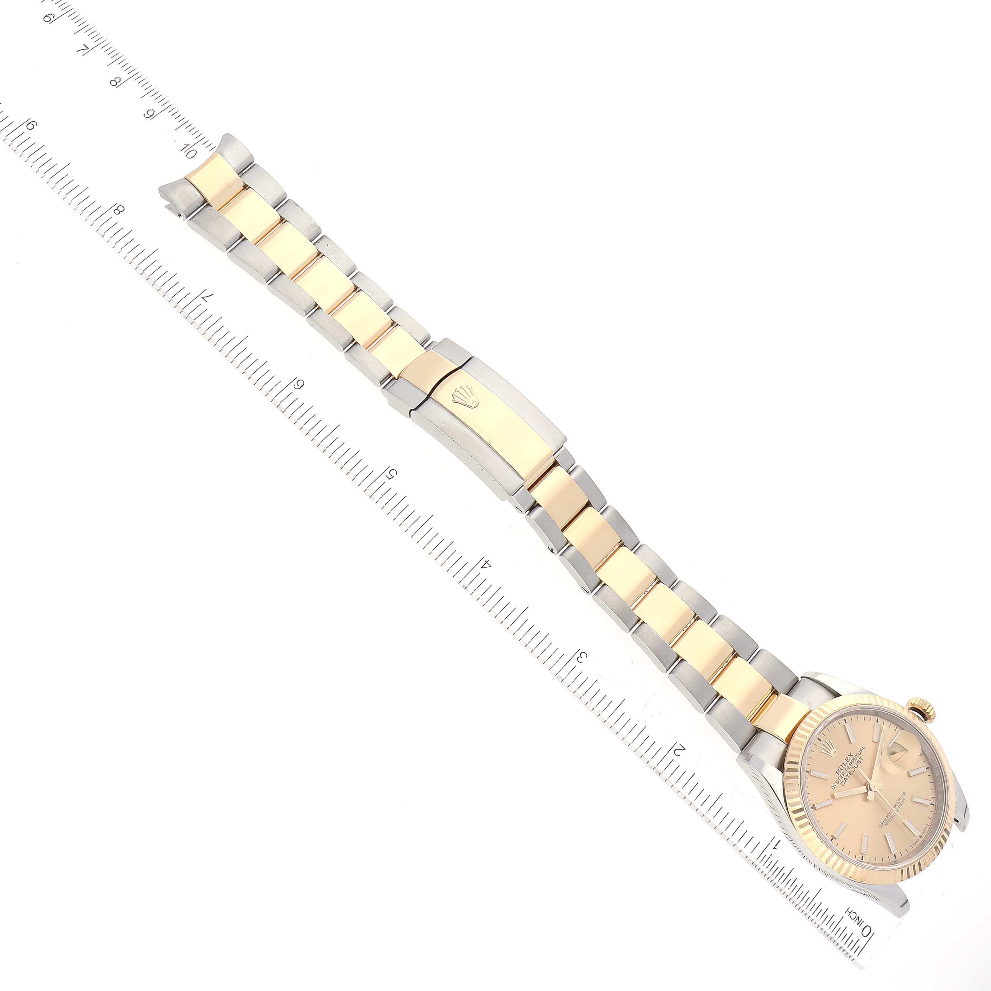 The image shows a Rolex Datejust 126233 Men's Steel and Gold (two tone) Champagne Dial 126233 Men's Steel and Gold (two tone) Champagne Dial watch from a top-down angle, featuring its face, bracelet, and clasp with an adjacent ruler.