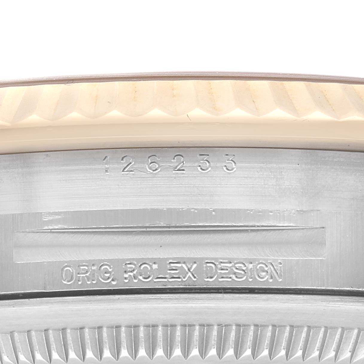 The image shows a close-up of the Rolex Datejust 126233 Men's Steel and Gold (two tone) Champagne Dial 126233 Men's Steel and Gold (two tone) Champagne Dial model's fluted bezel and part of the case with model and branding engravings.