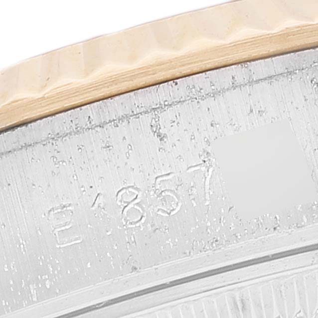 This close-up of the Rolex Datejust 69173 Women's Steel and Gold (two tone) Champagne Dial 69173 Women's Steel and Gold (two tone) Champagne Dial watch captures the edge of the fluted bezel and part of the inner case showing engraved numbers.