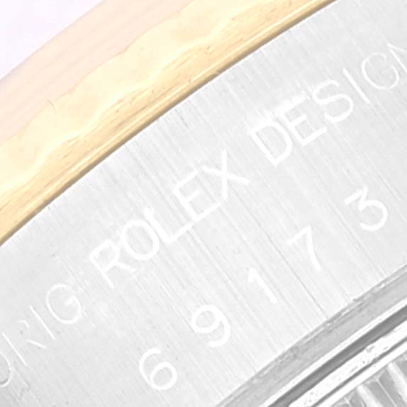 This image shows a close-up of the engraved side of the bezel on a Rolex Datejust 69173 Women's Steel and Gold (two tone) Champagne Dial 69173 Women's Steel and Gold (two tone) Champagne Dial model watch.
